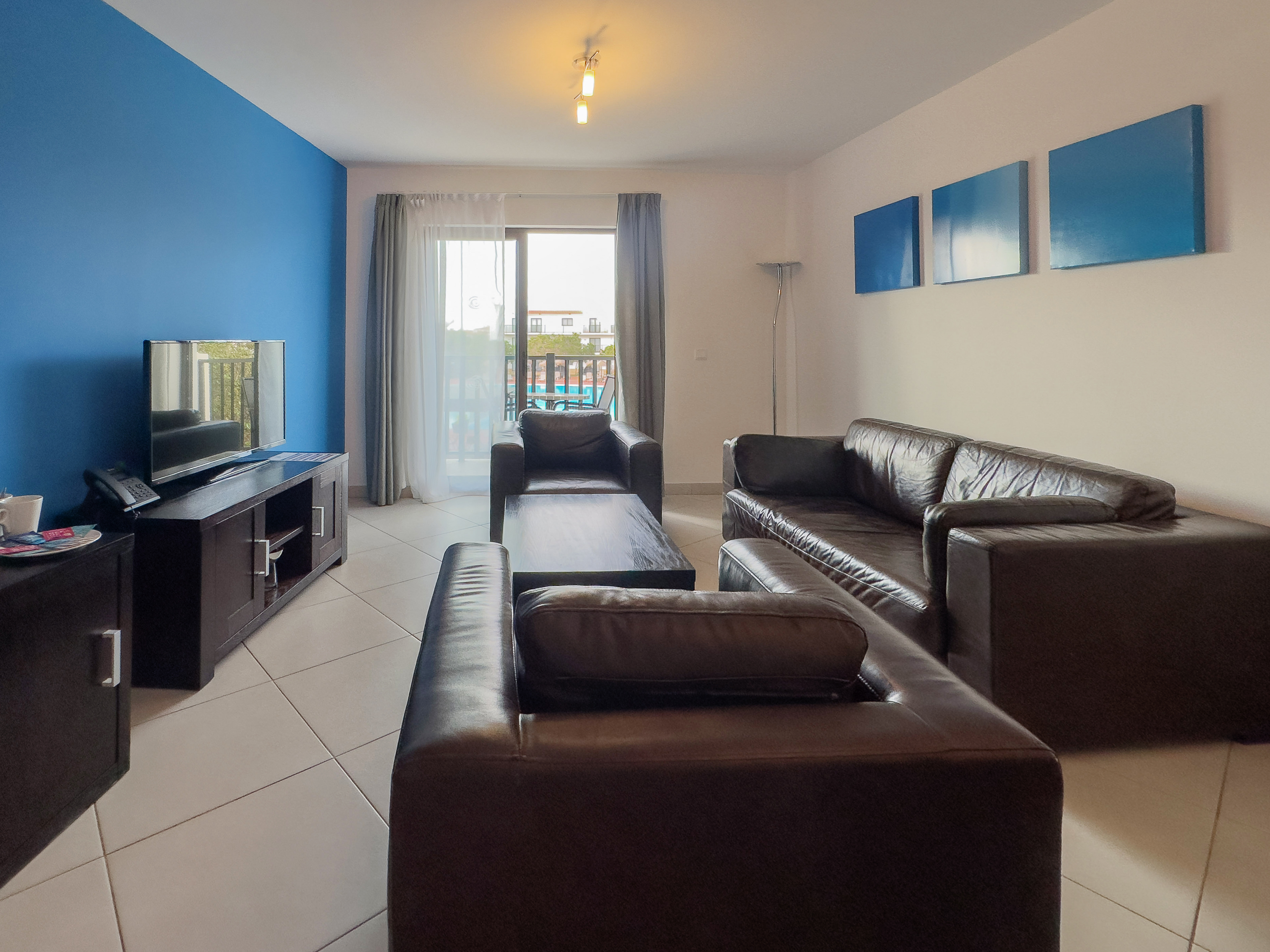 a living room with leather couches and a television