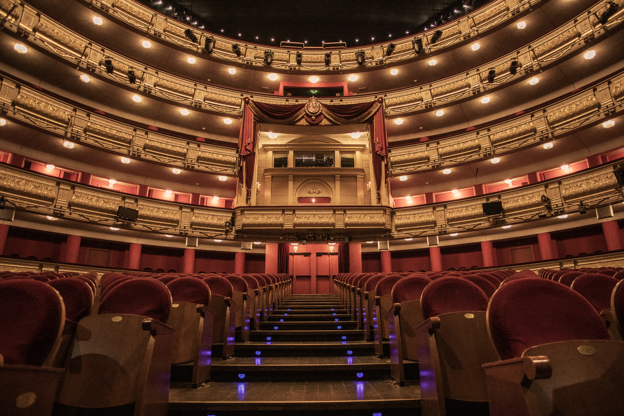 a theater with red seats and red curtains
