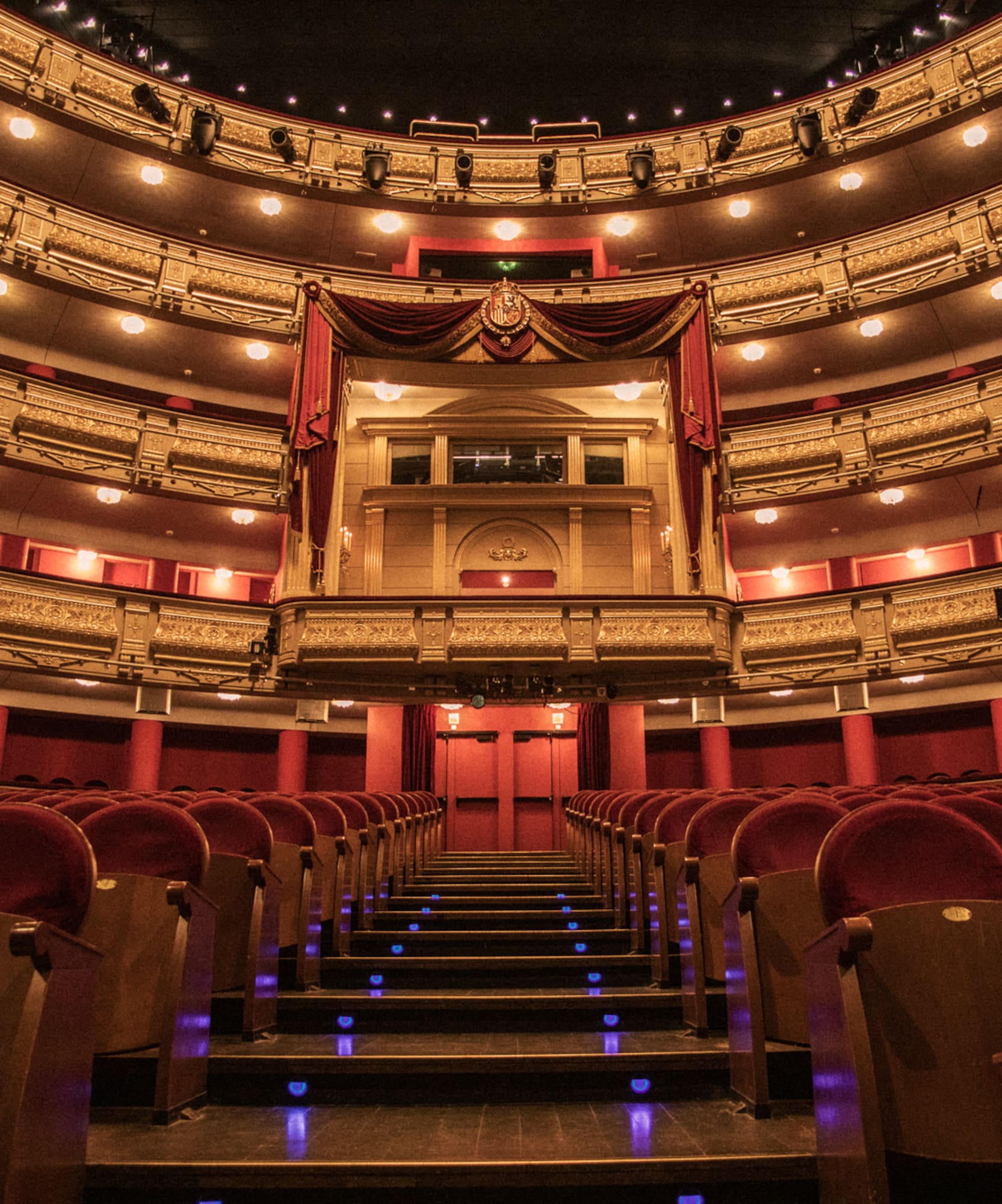 a theater with red seats and red curtains