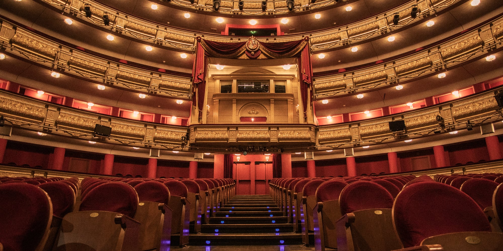 a theater with red seats and red curtains