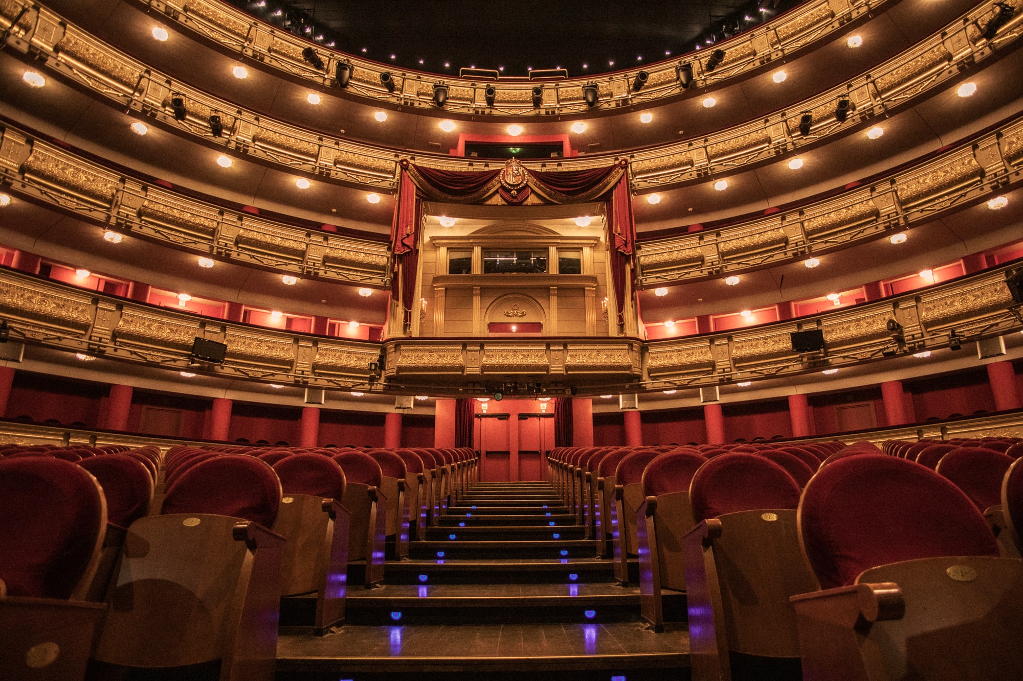 a theater with red seats and red curtains
