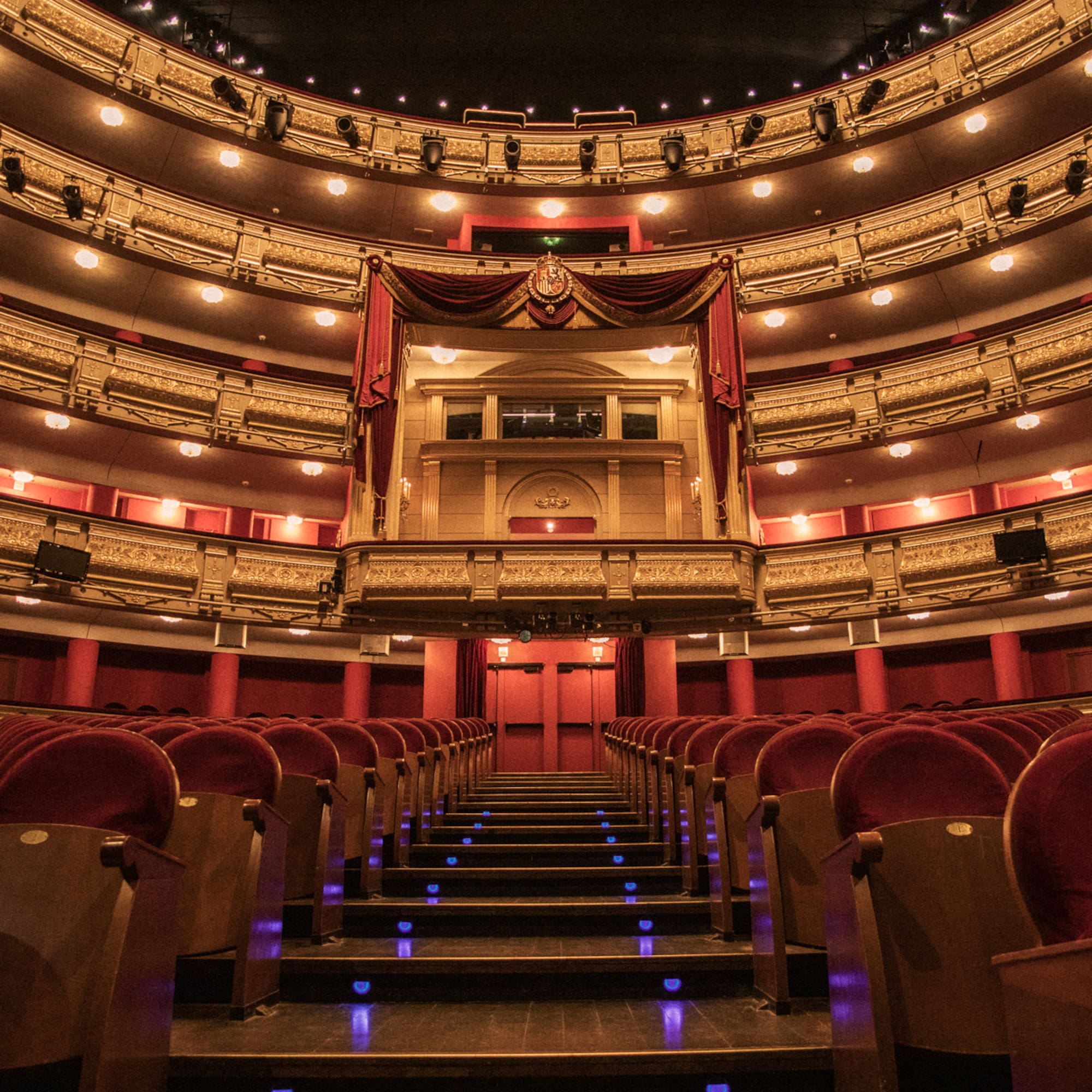 a theater with red seats and red curtains