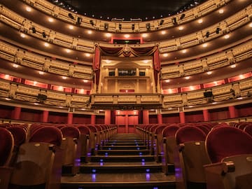 a theater with red seats and red curtains