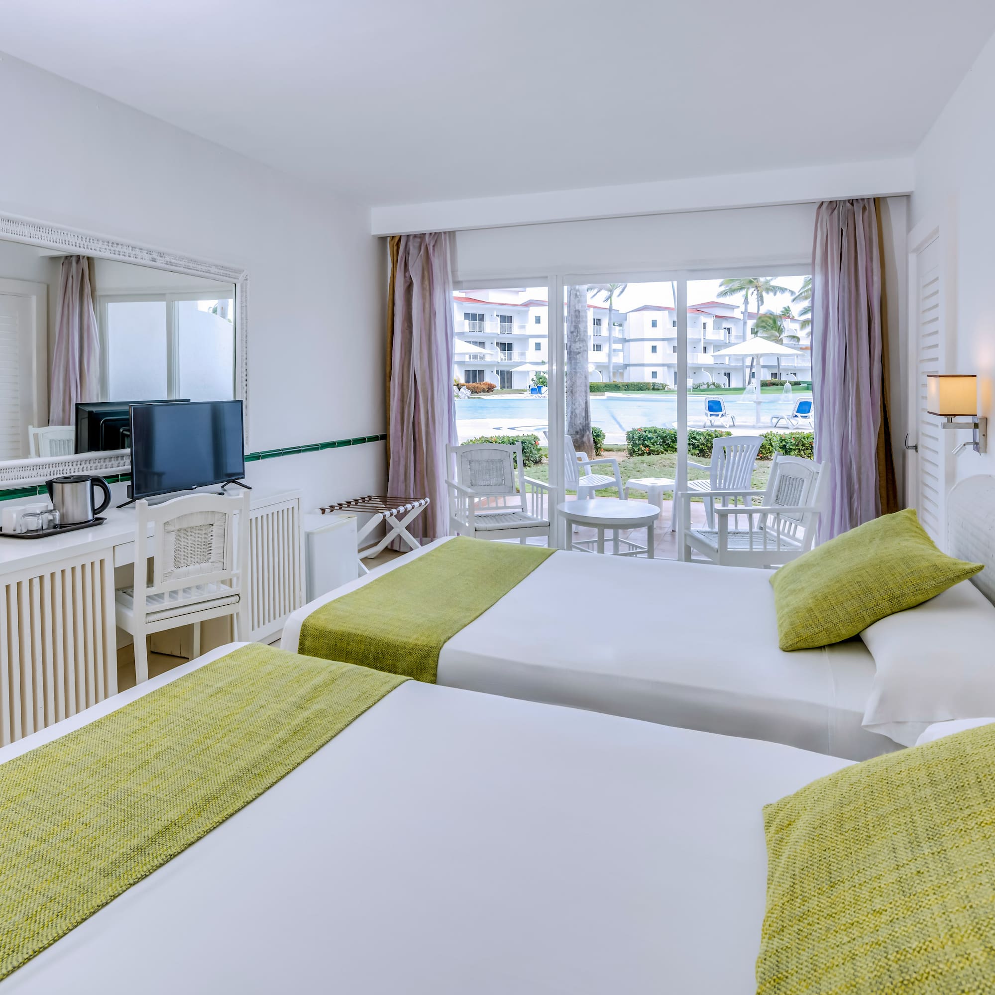 a room with two beds and a television