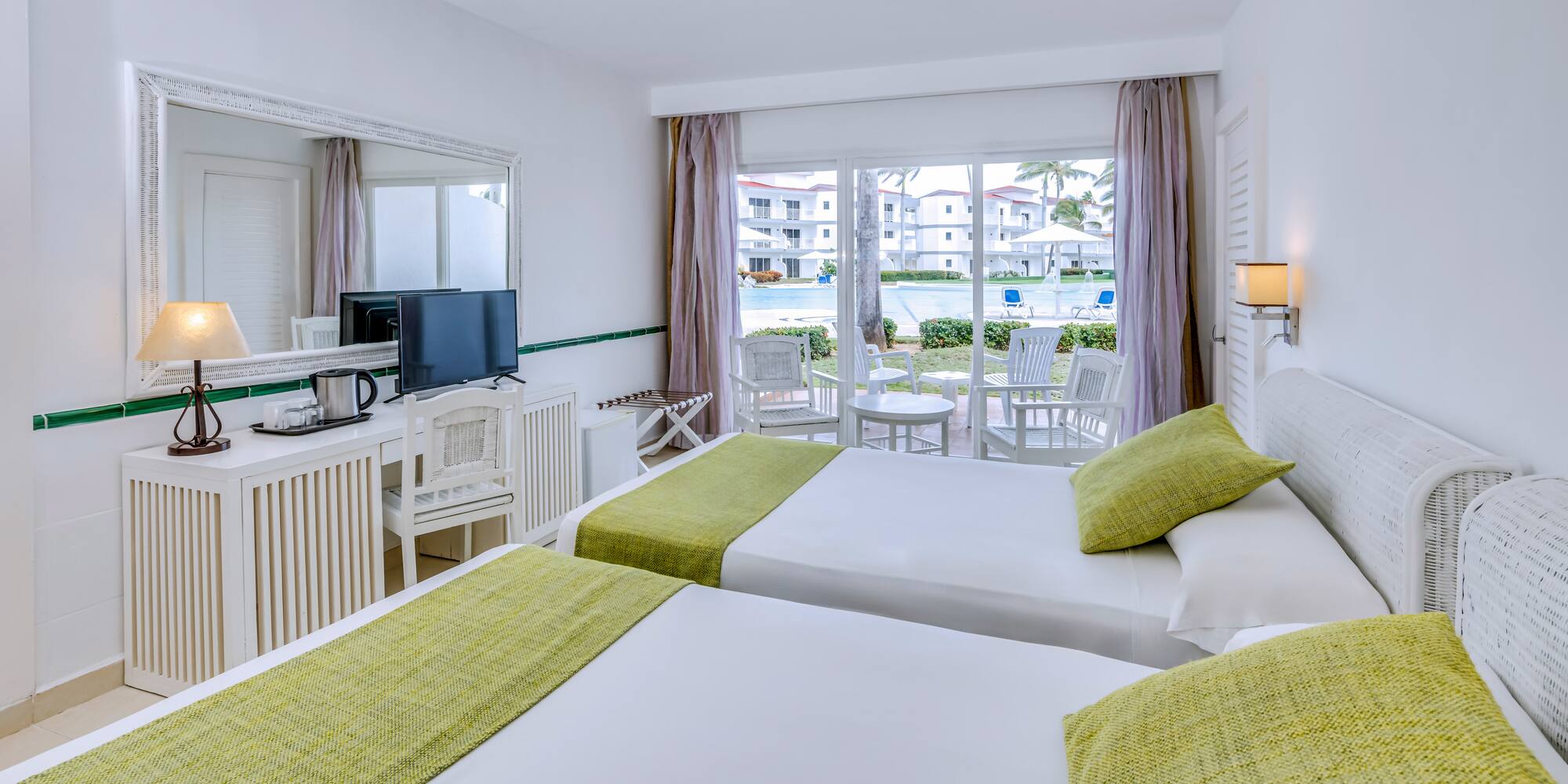 a room with two beds and a television