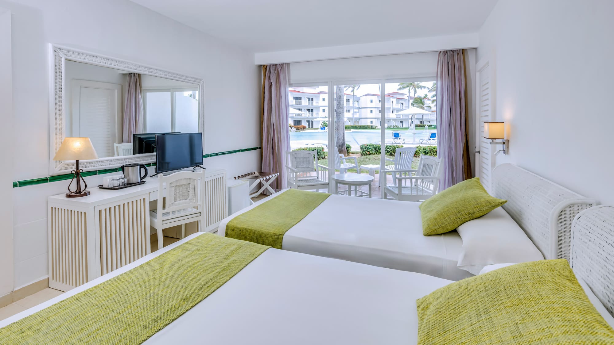 a room with two beds and a television