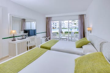 a room with two beds and a television