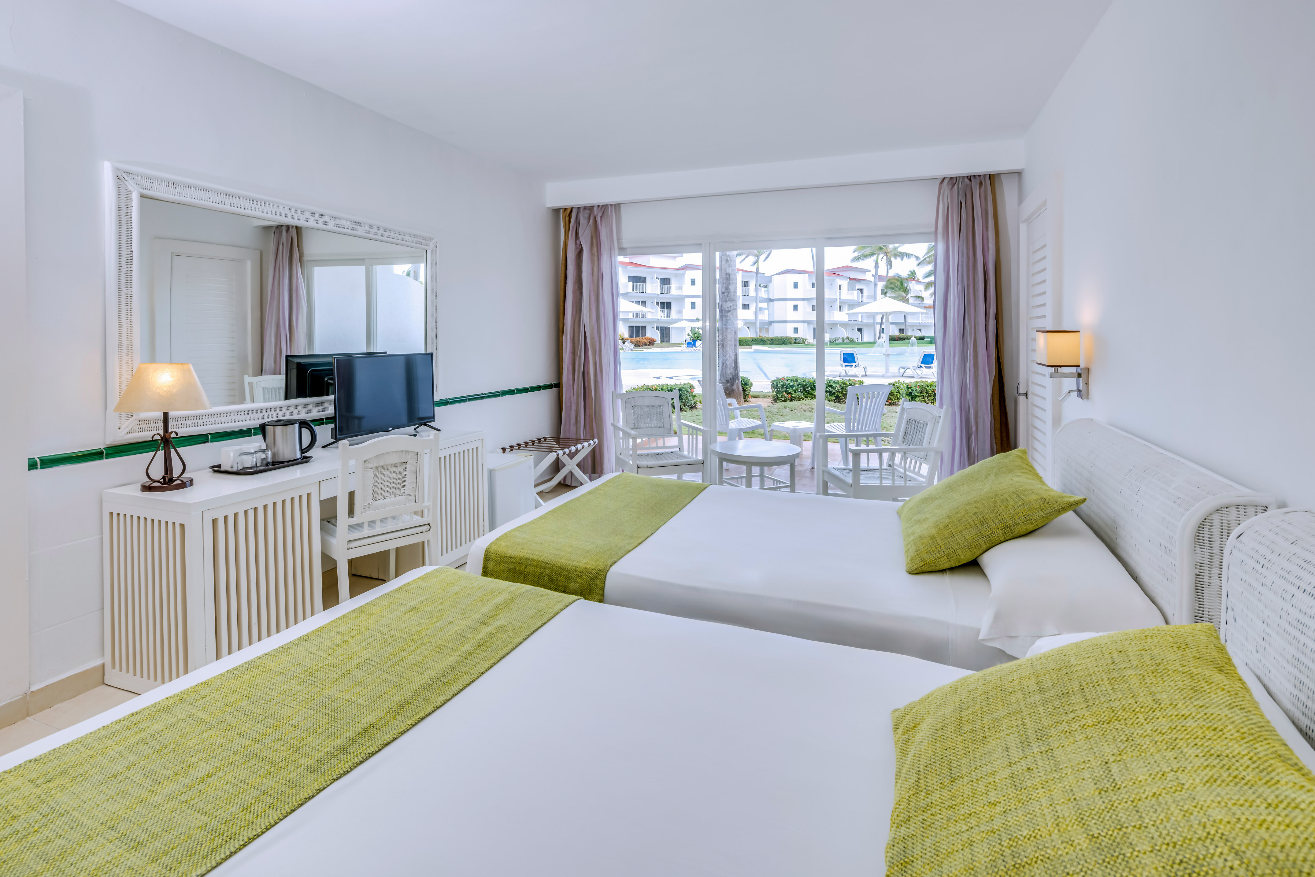 a room with two beds and a television