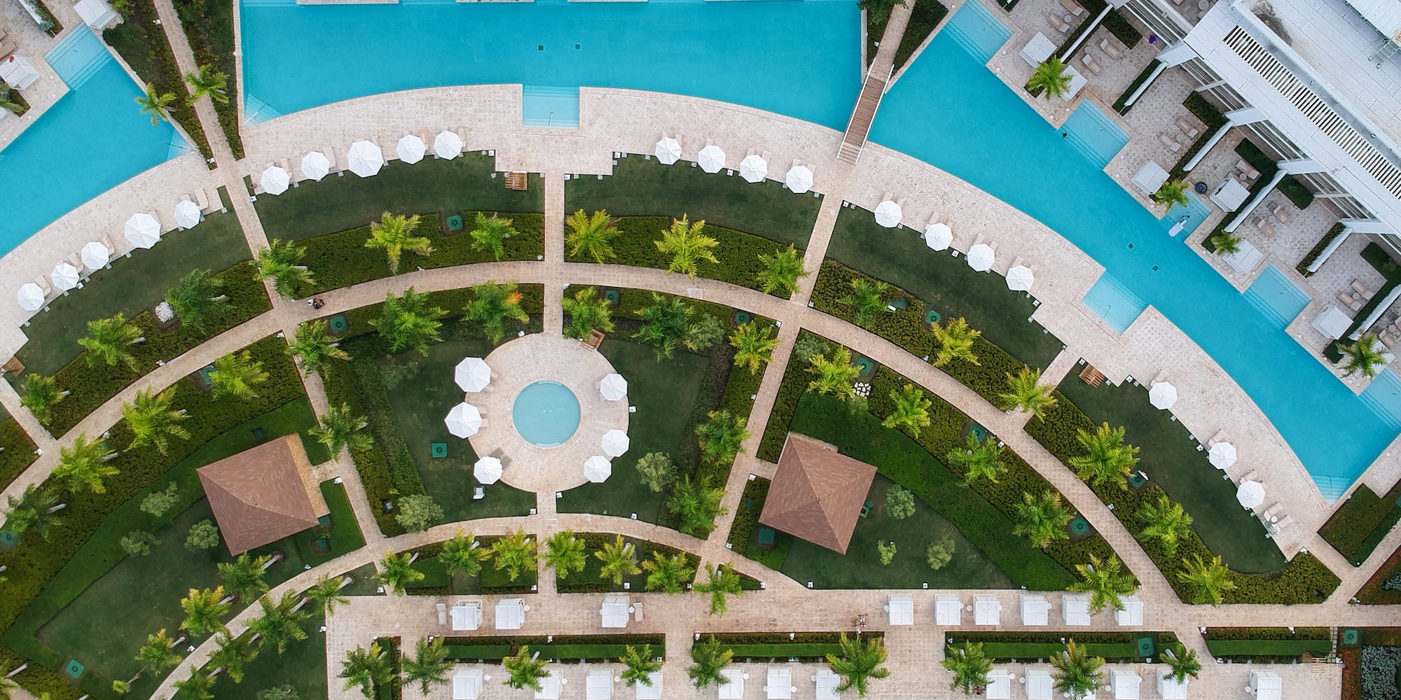 an aerial view of a resort with pool and trees