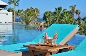 a table with drinks on it by a pool