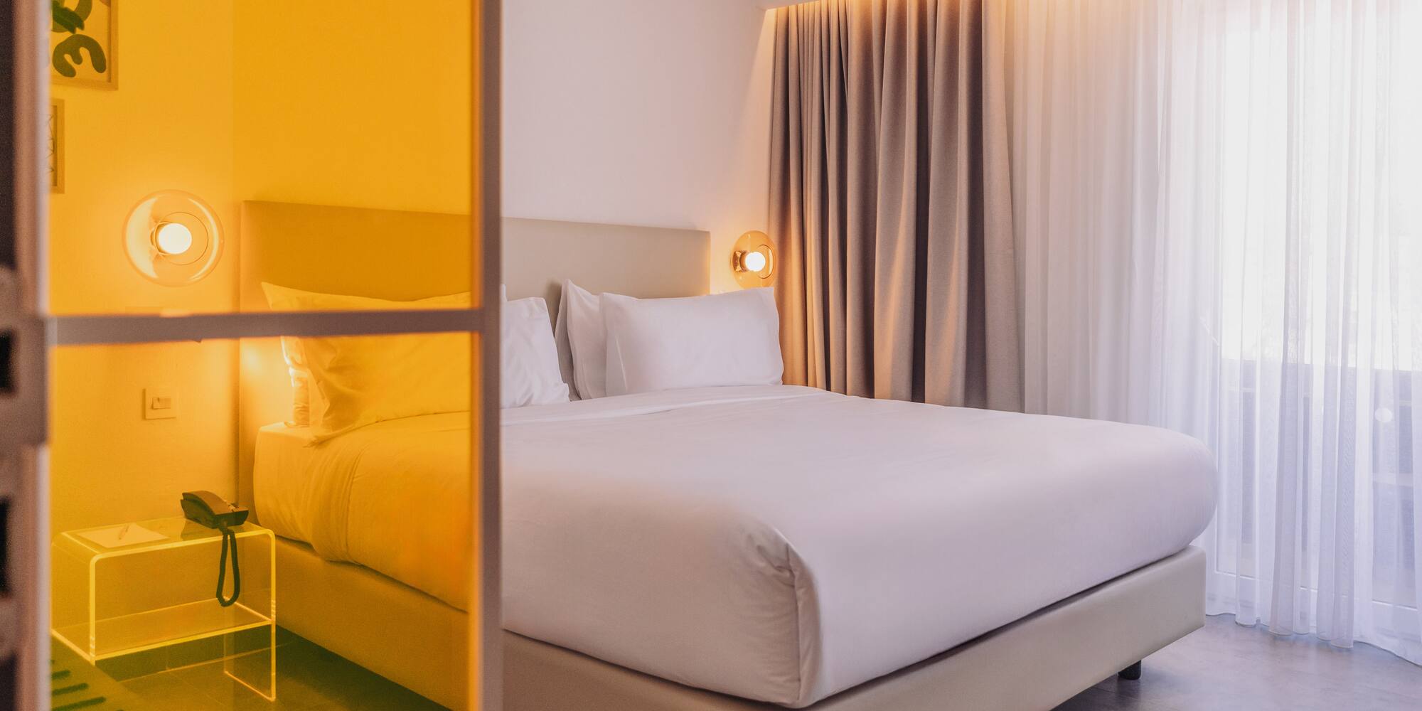 a bed with white sheets and a lamp