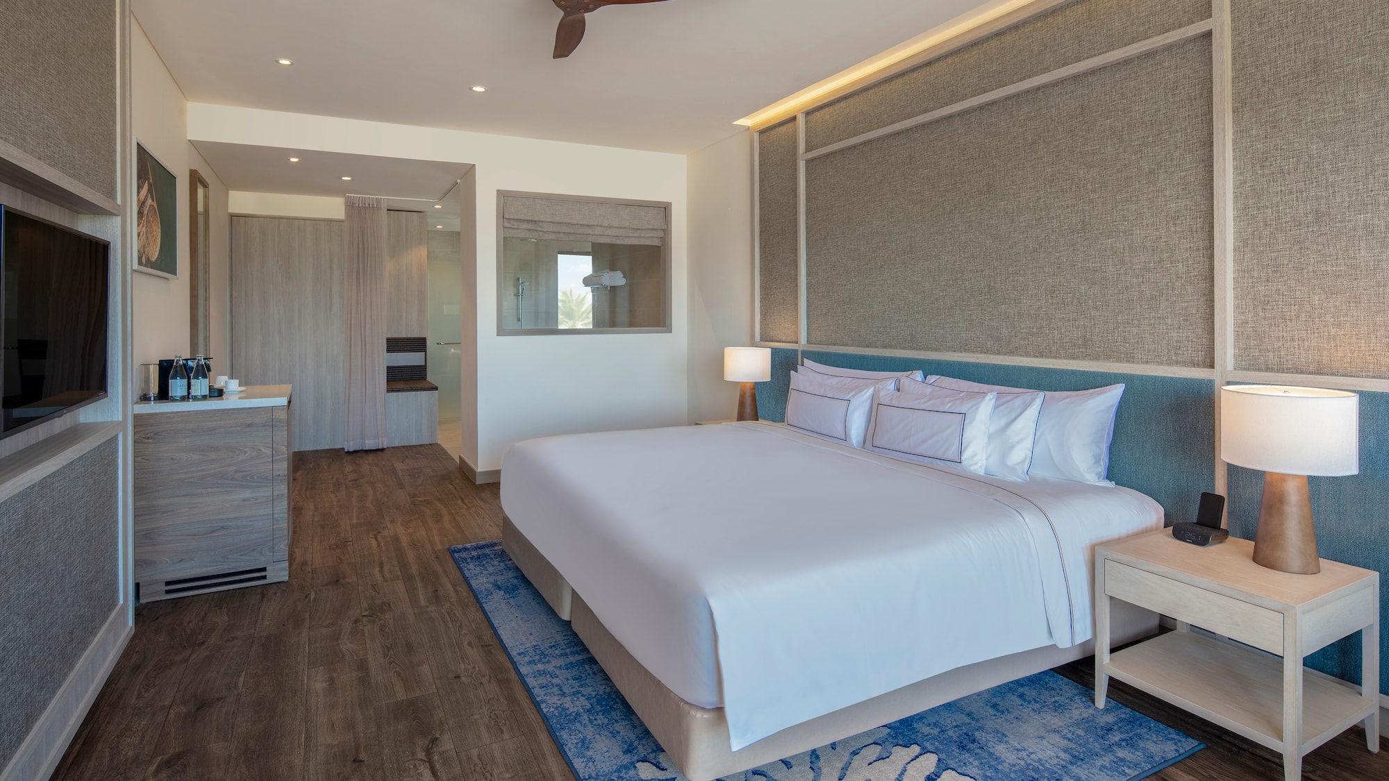 a room with a bed and a ceiling fan