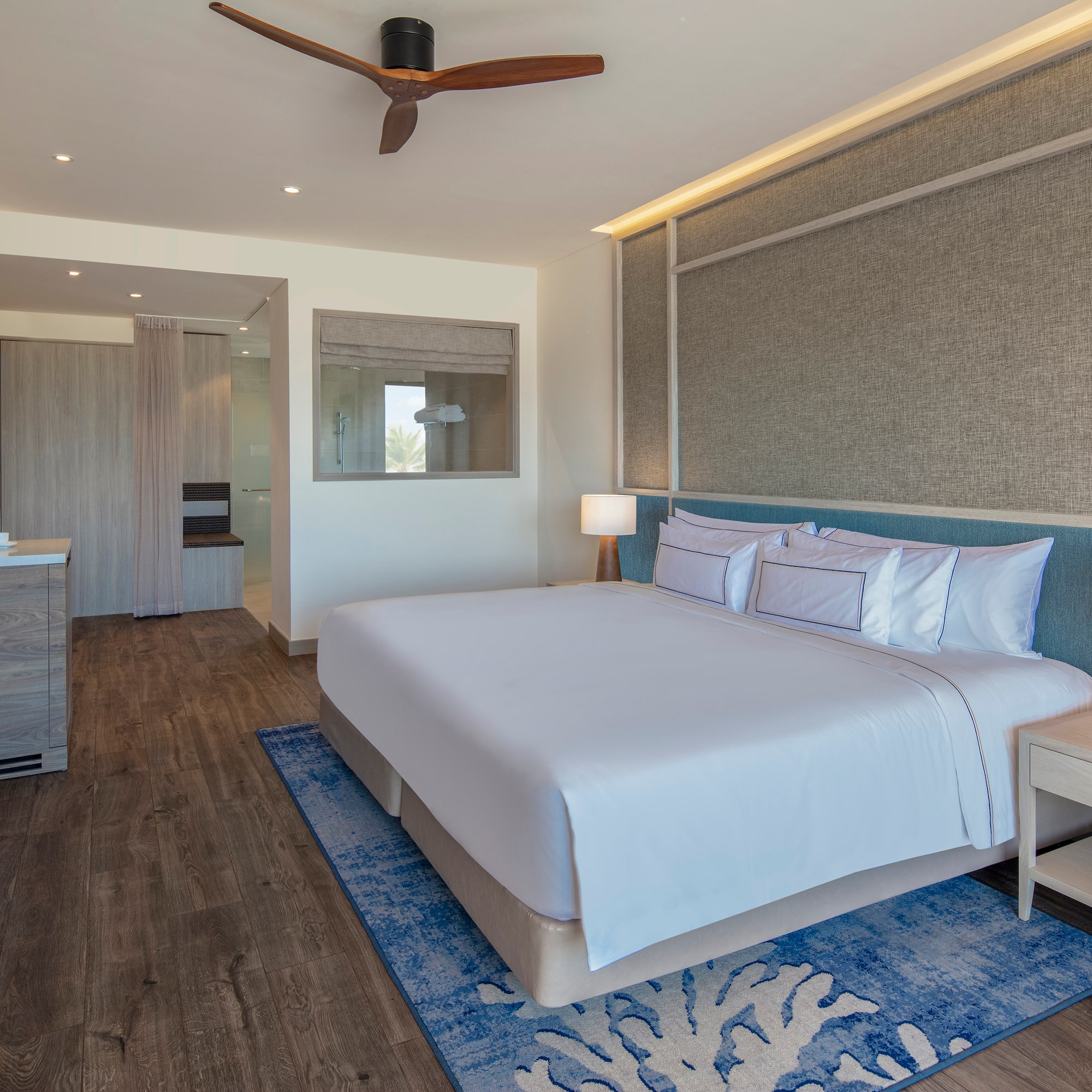 a room with a bed and a ceiling fan