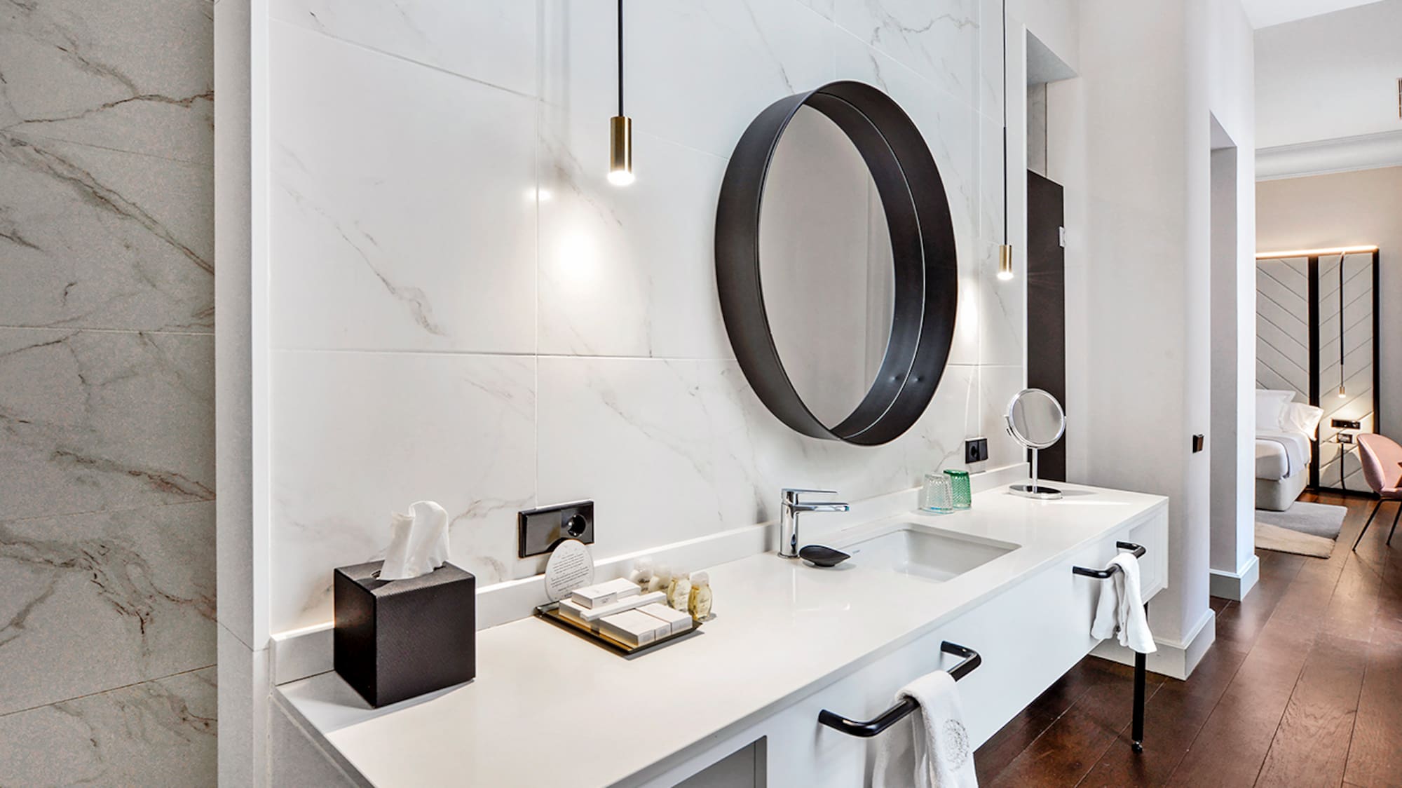 a bathroom with a mirror and a marble wall
