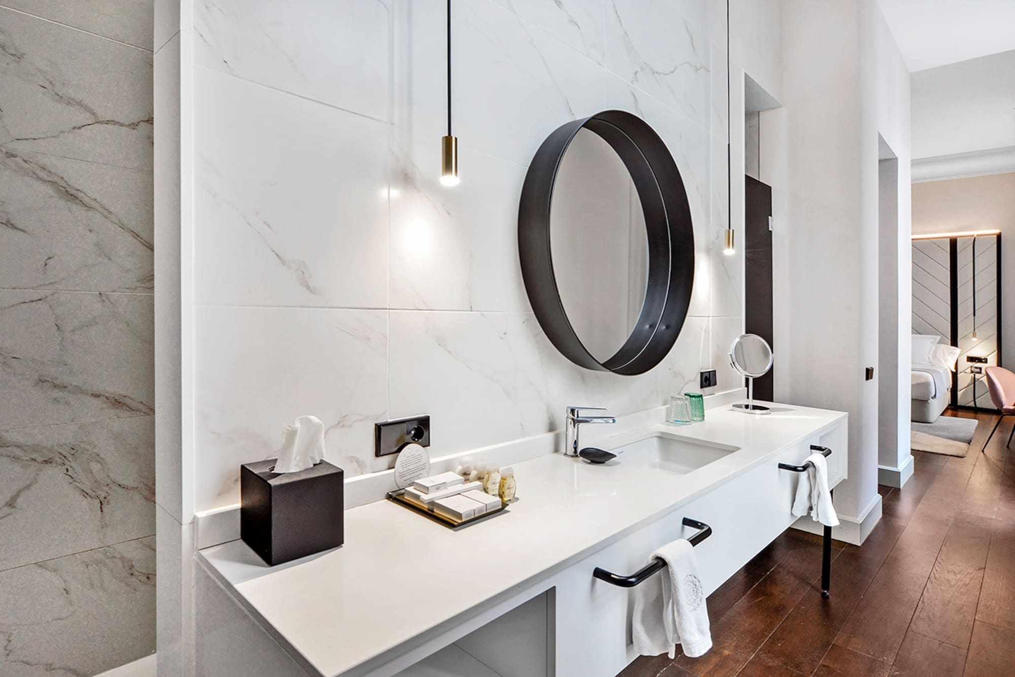 a bathroom with a mirror and a marble wall