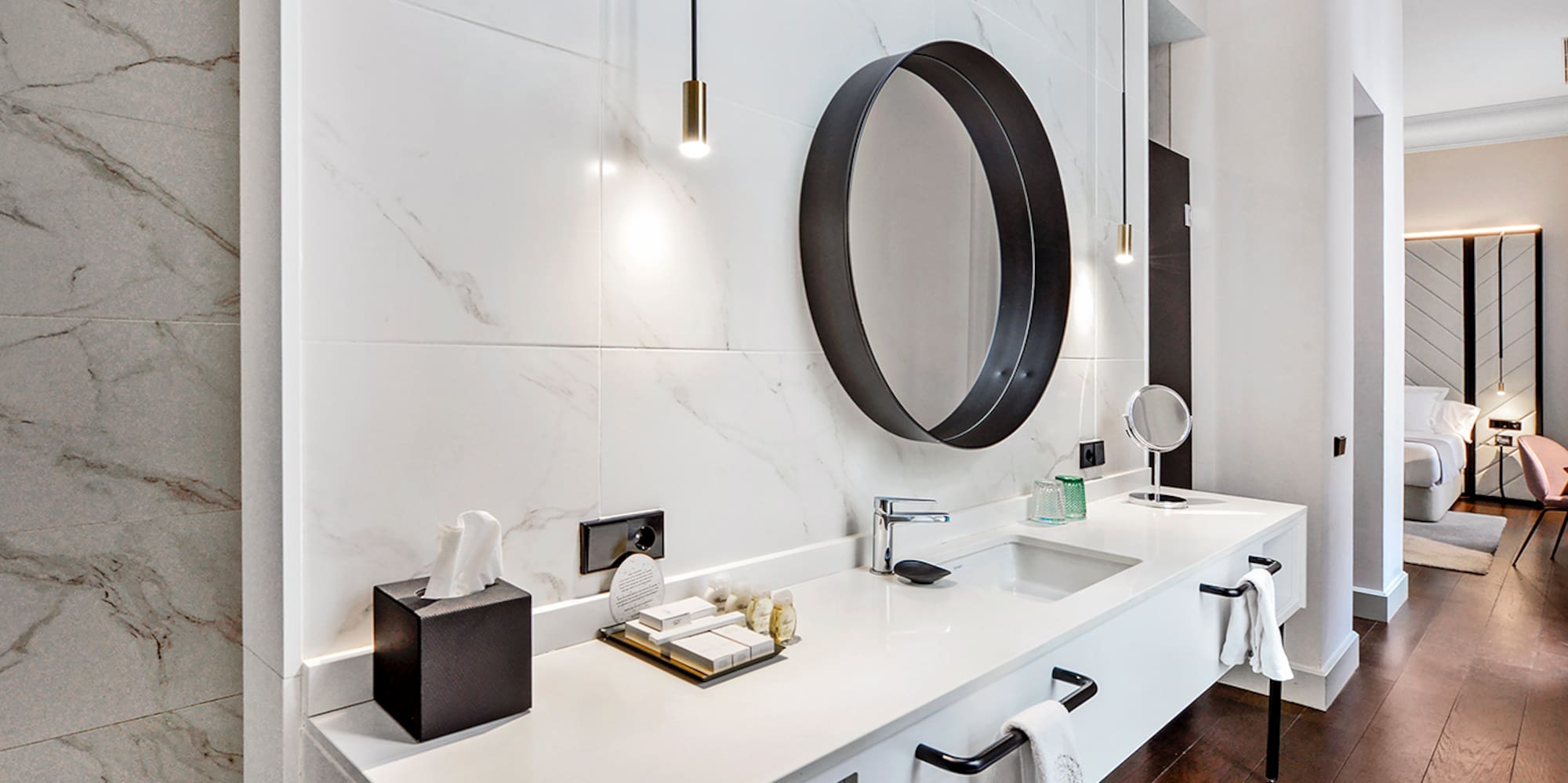 a bathroom with a mirror and a marble wall