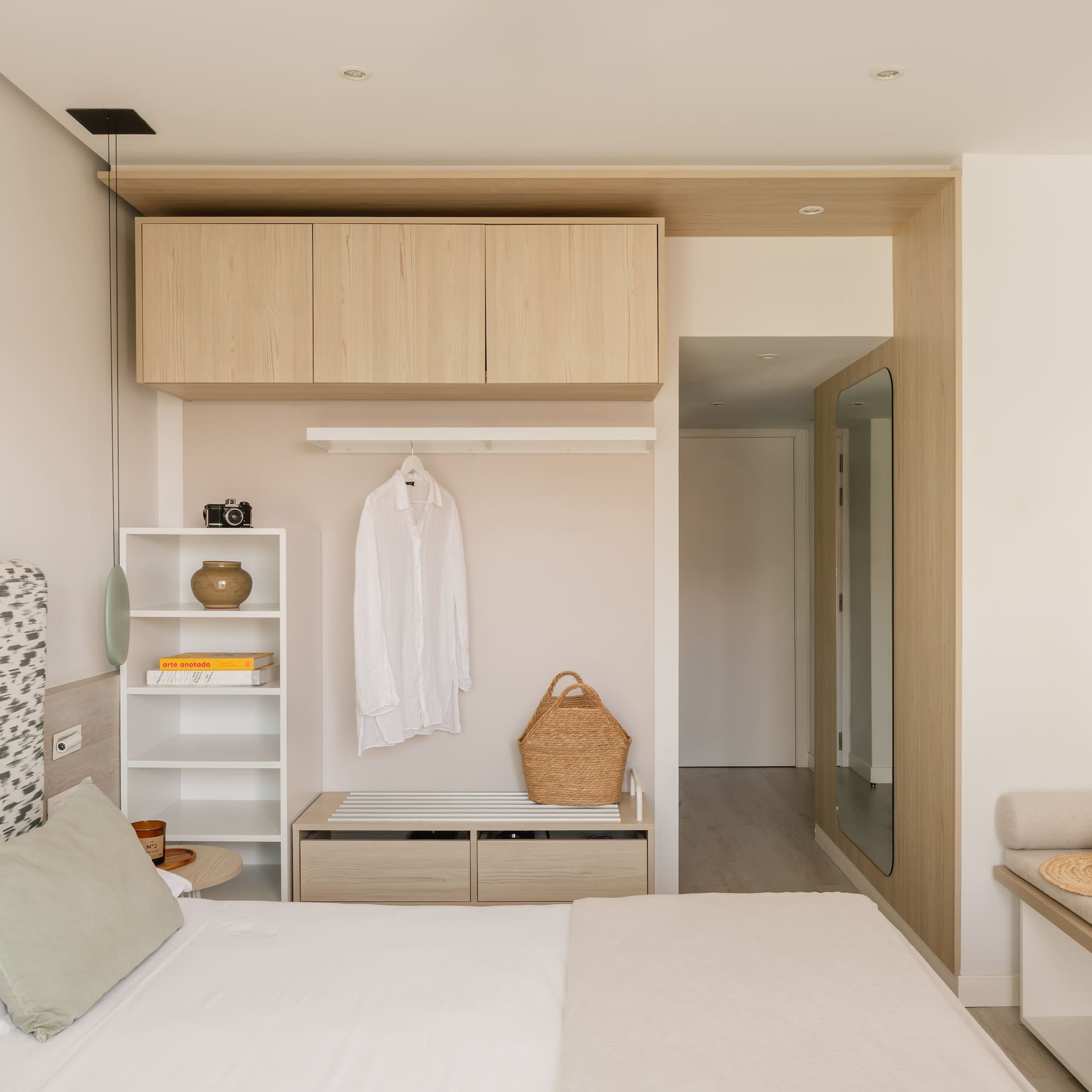 a bedroom with a bed and a shelf