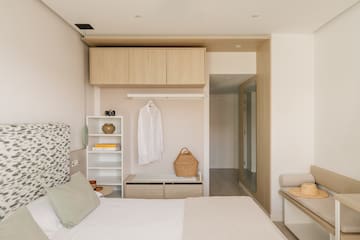 a bedroom with a bed and a shelf