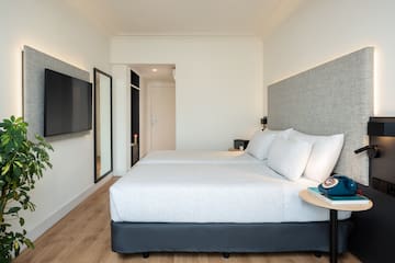 a room with two beds and a tv