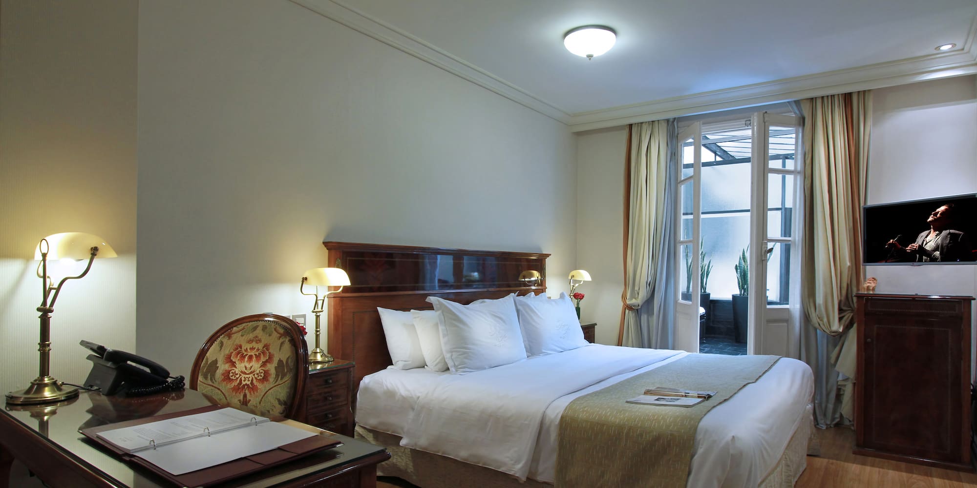 a bedroom with a bed and a desk