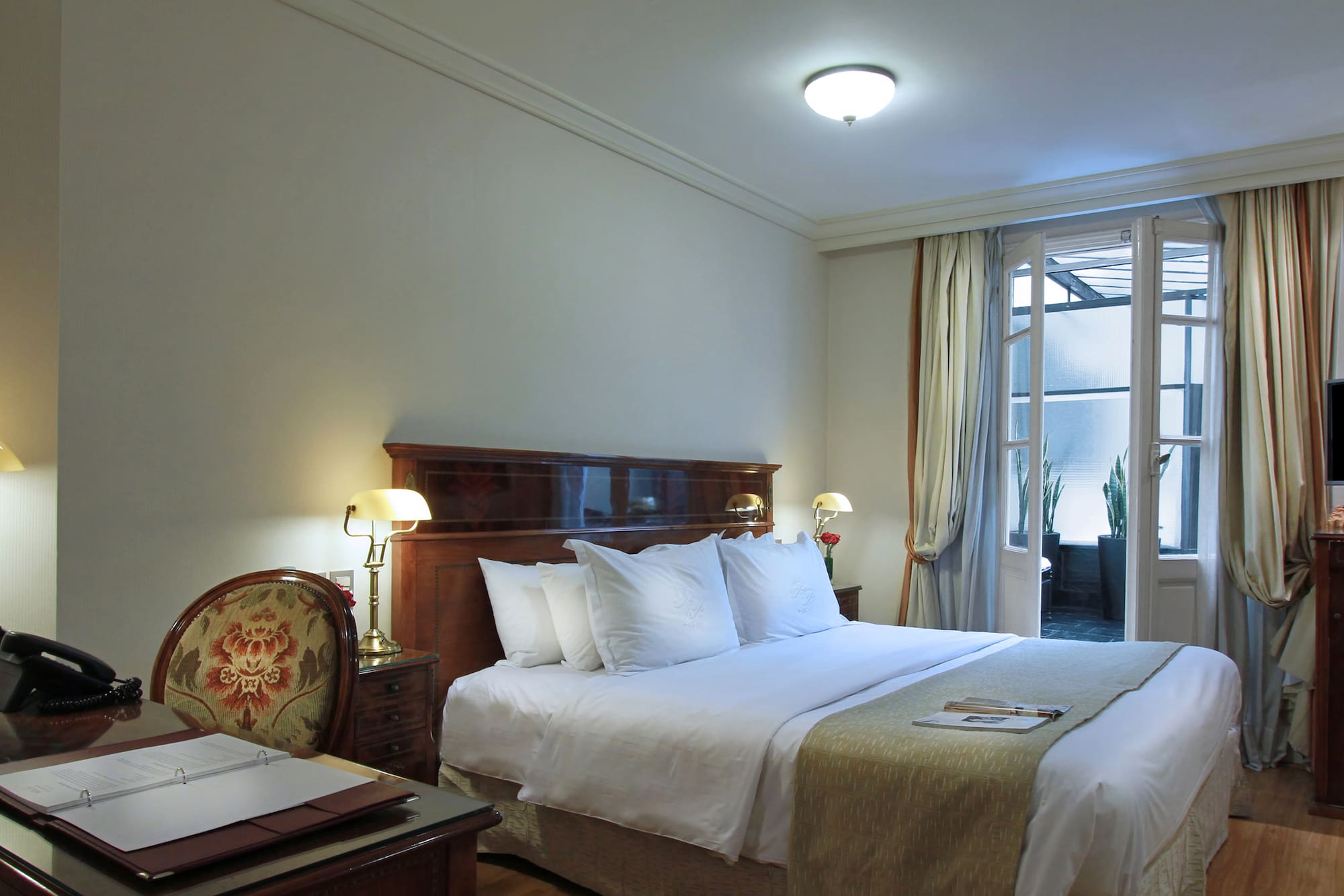 a bedroom with a bed and a desk