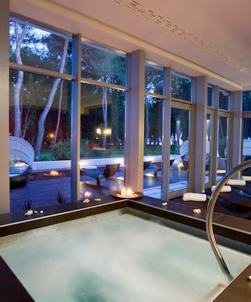 a hot tub inside a room with large windows