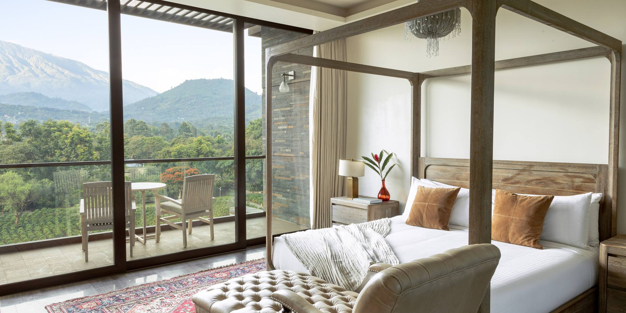 a bedroom with a four poster bed and a chair