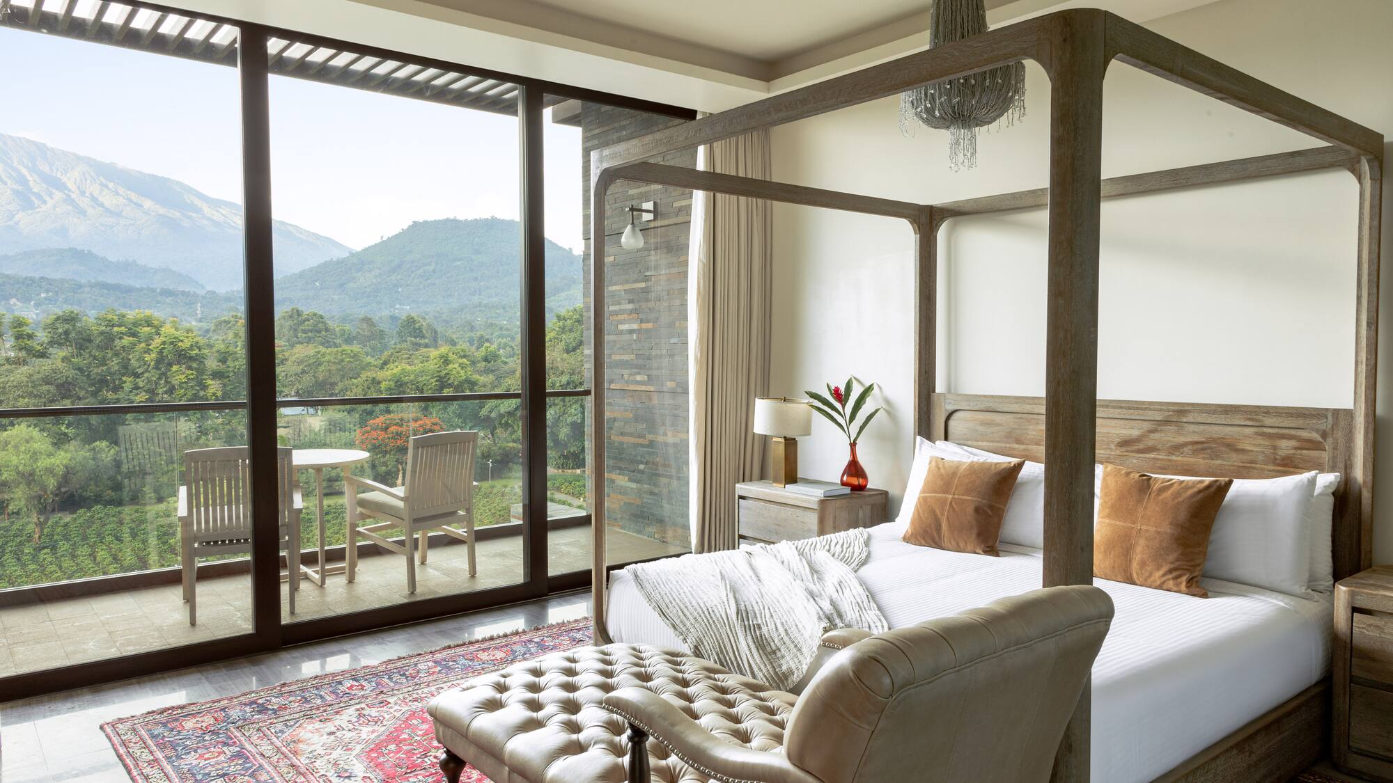 a bedroom with a four poster bed and a chair