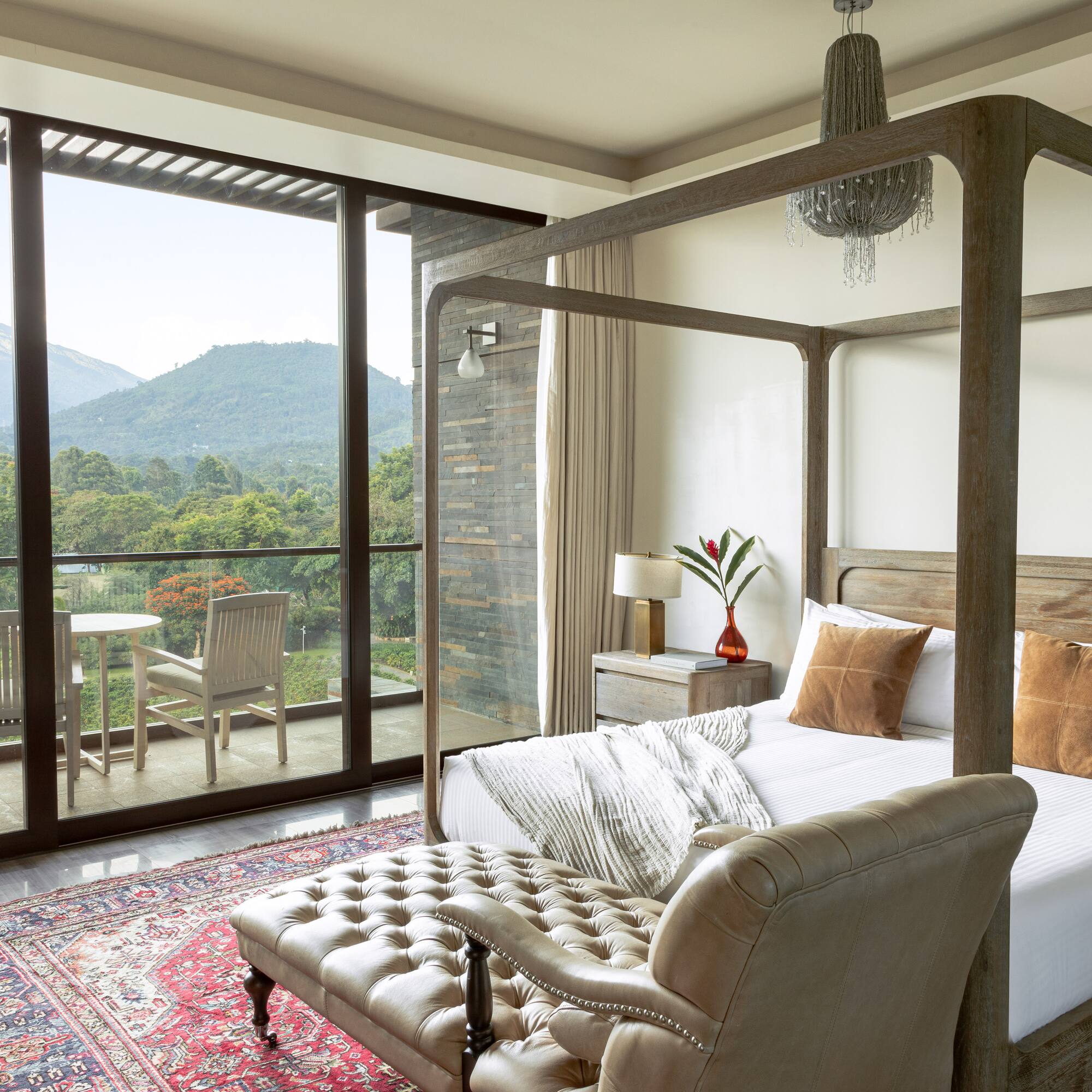 a bedroom with a four poster bed and a chair