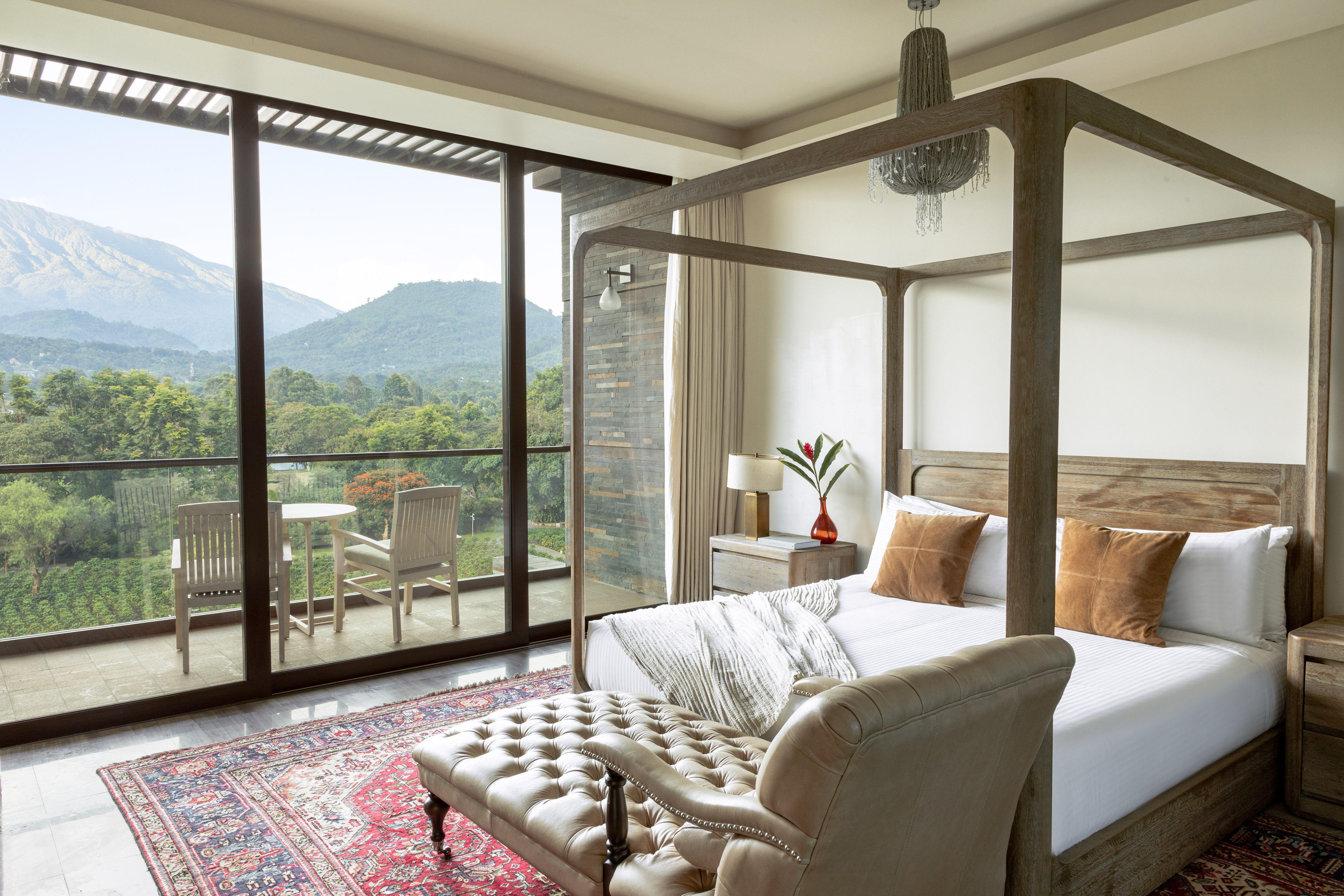 a bedroom with a four poster bed and a chair