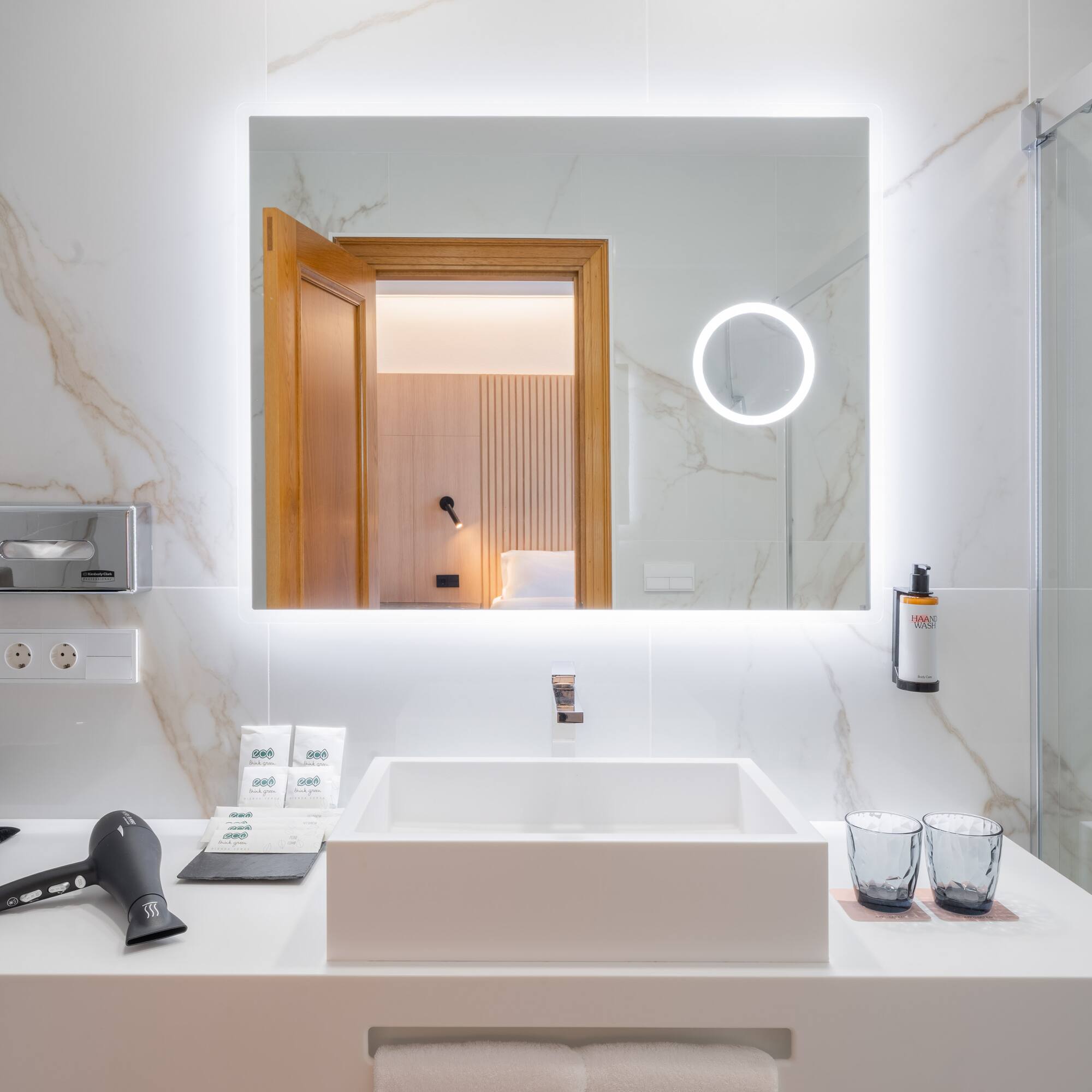 a bathroom with a mirror and a sink