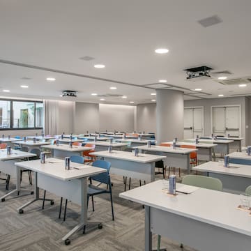 a room with many tables and chairs