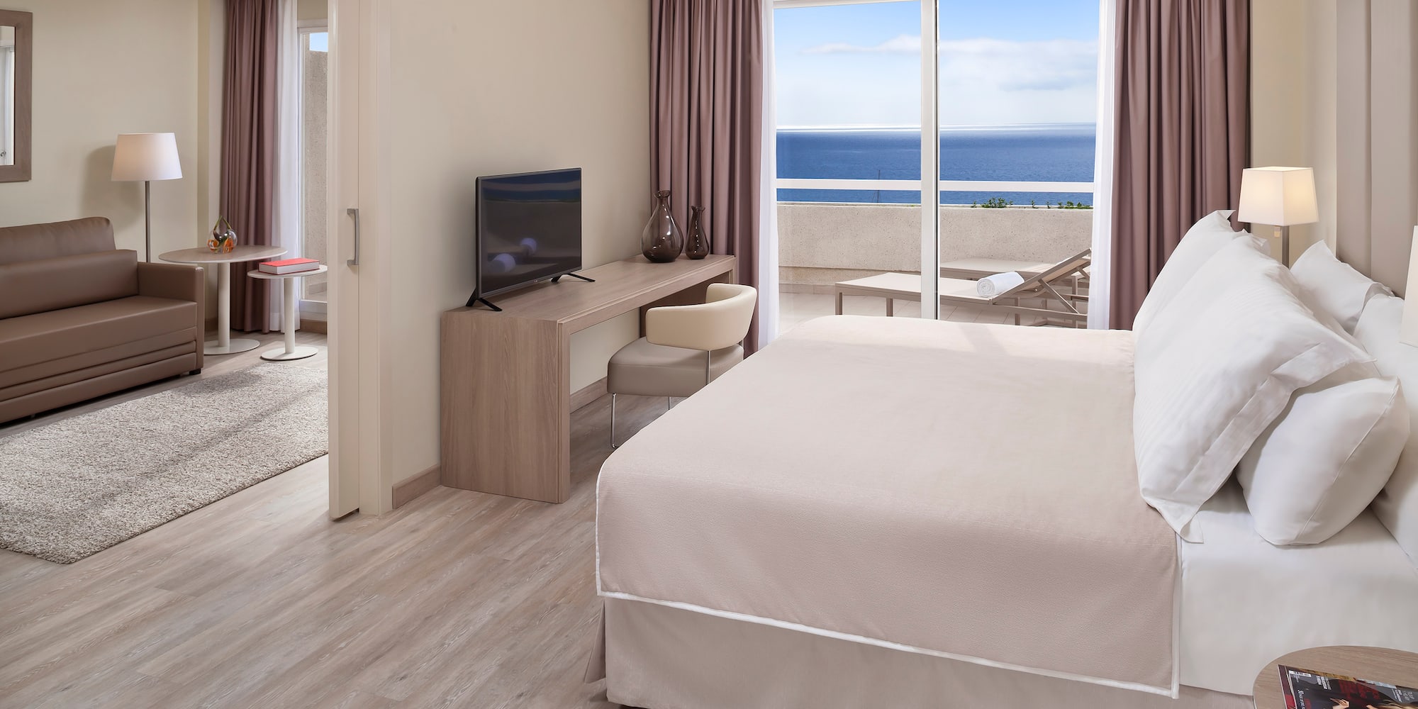 a room with a bed and a television