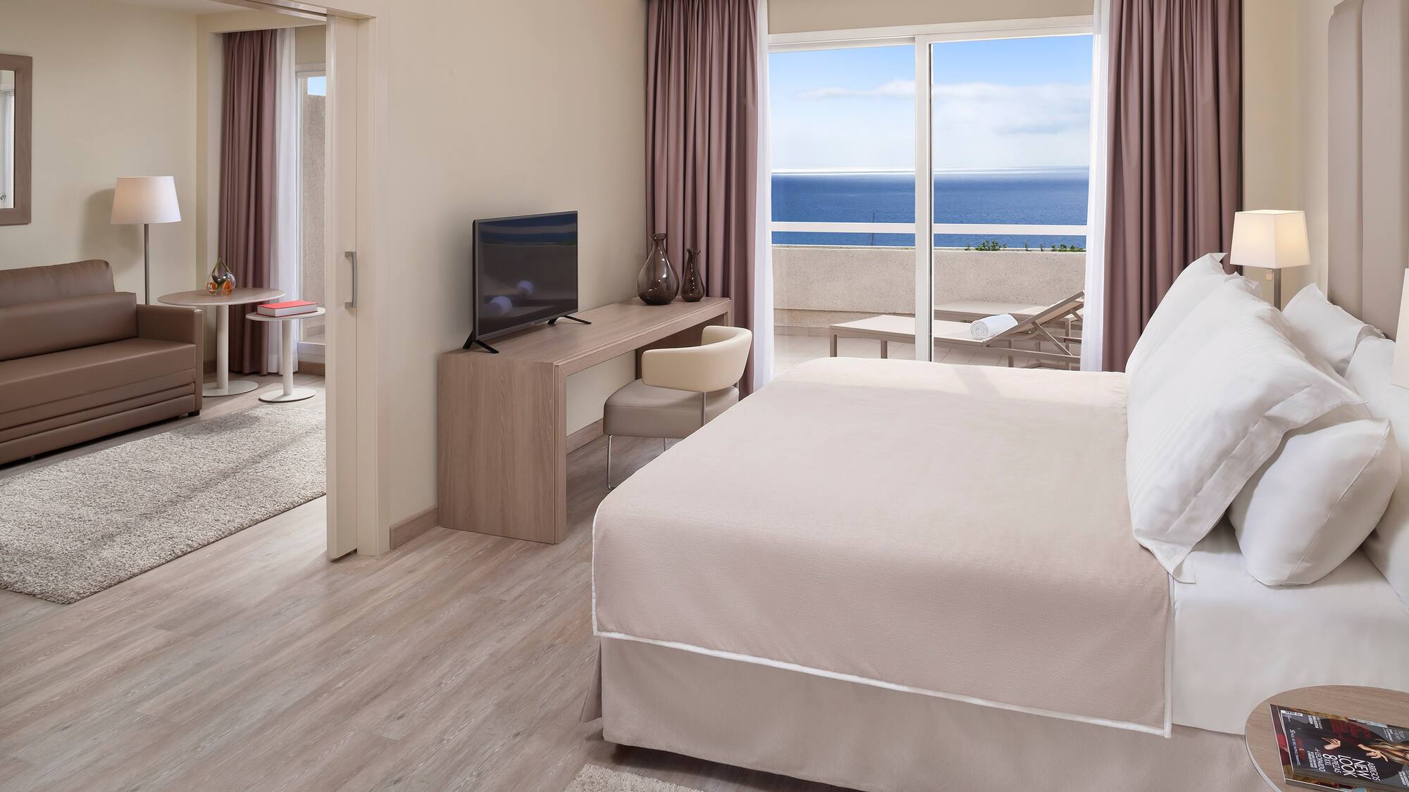 a room with a bed and a television