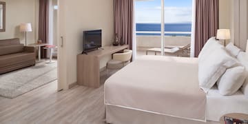 a room with a bed and a television