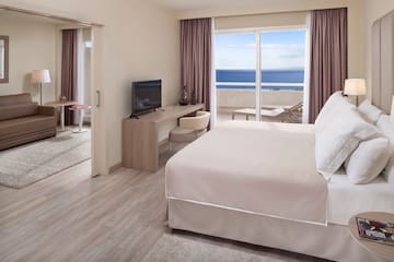 a room with a bed and a television
