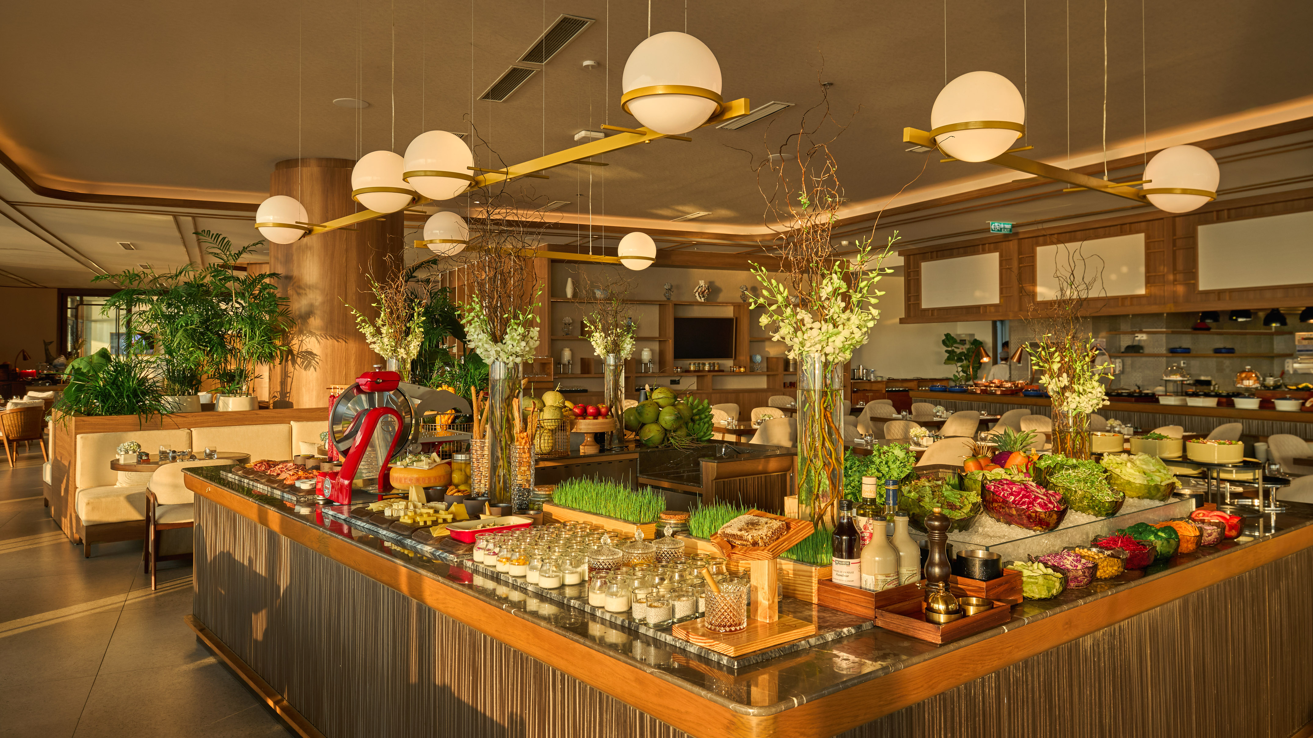 Luxurious hotel breakfast buffet with fresh salads, fruits, and cold cuts.