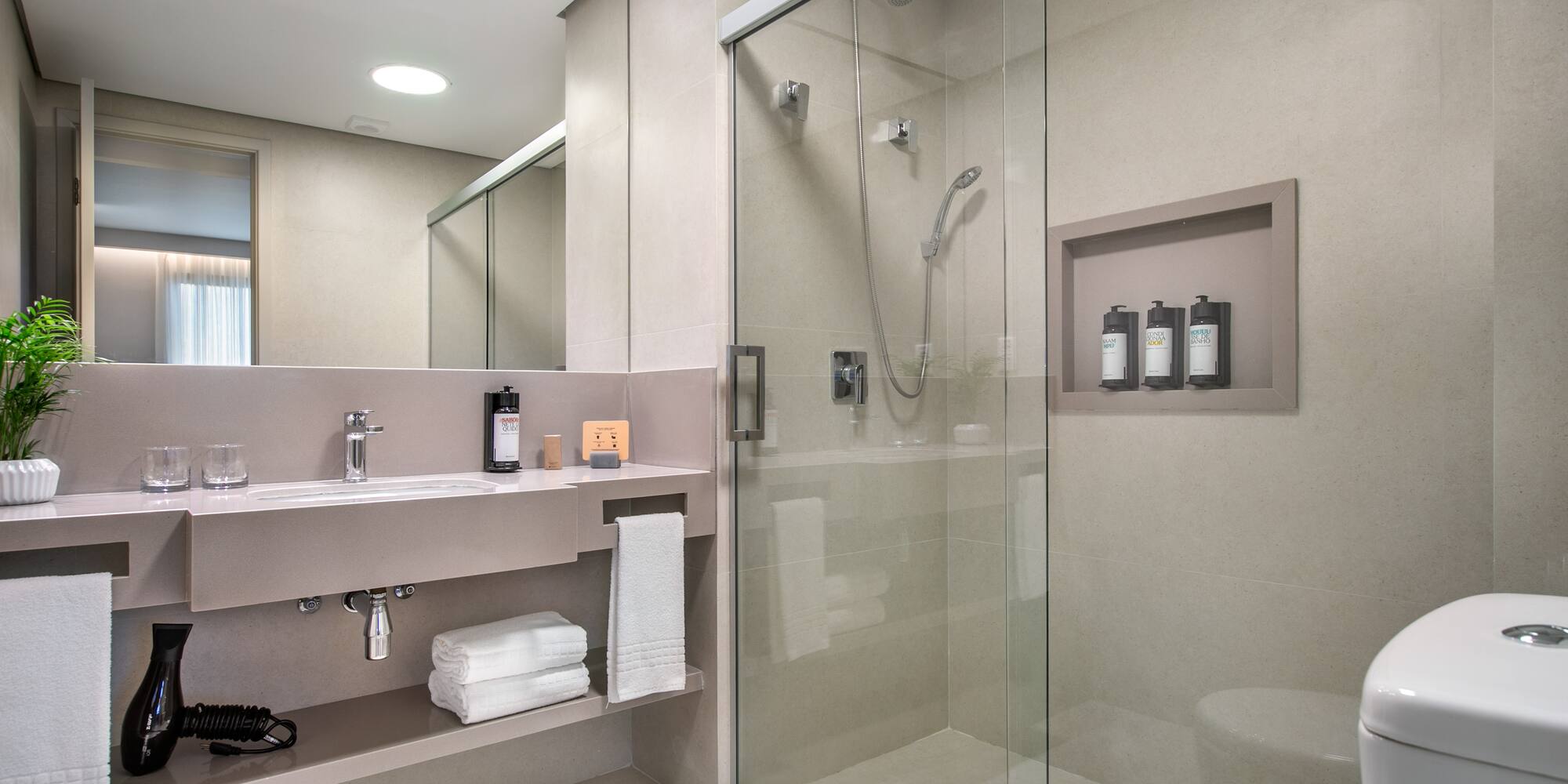 a bathroom with a glass shower and a toilet
