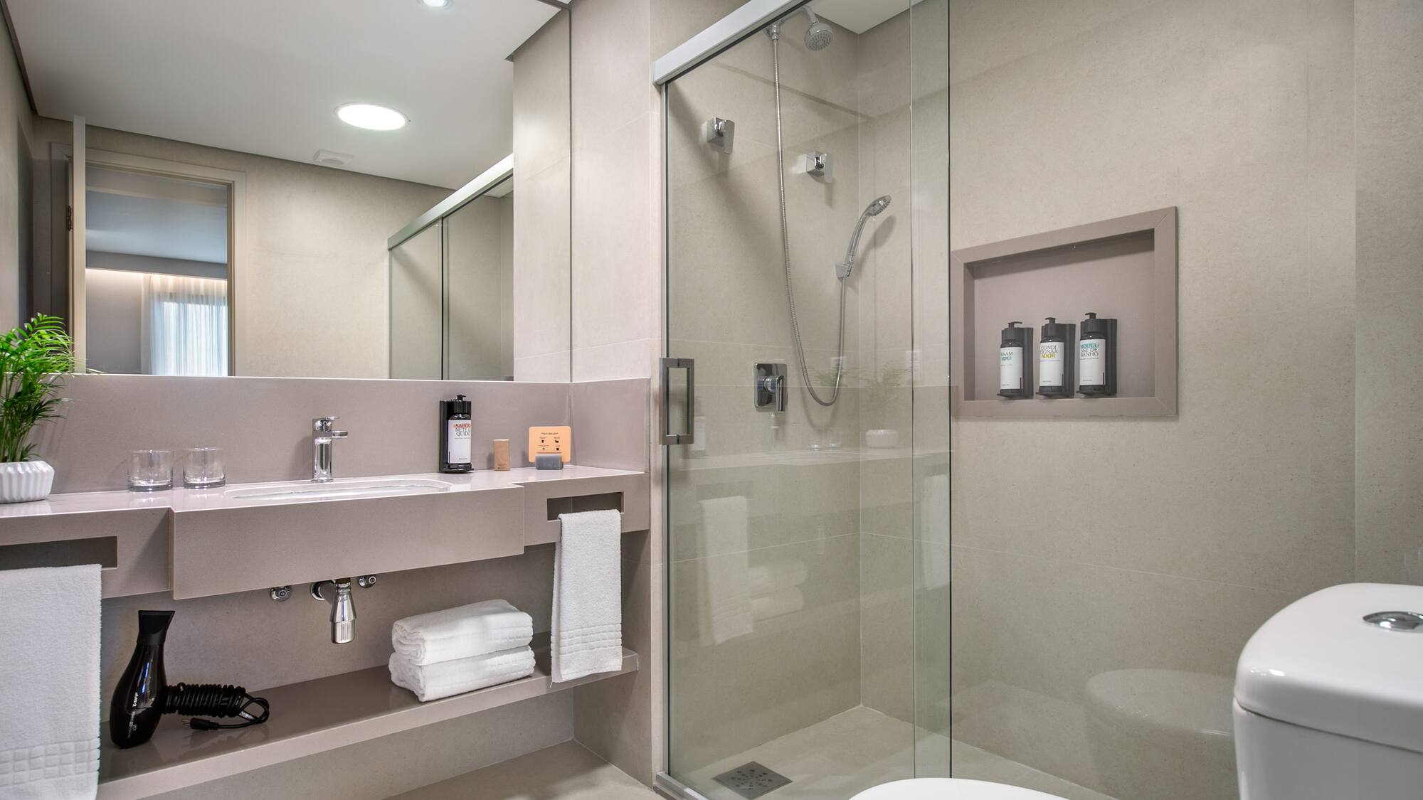a bathroom with a glass shower and a toilet