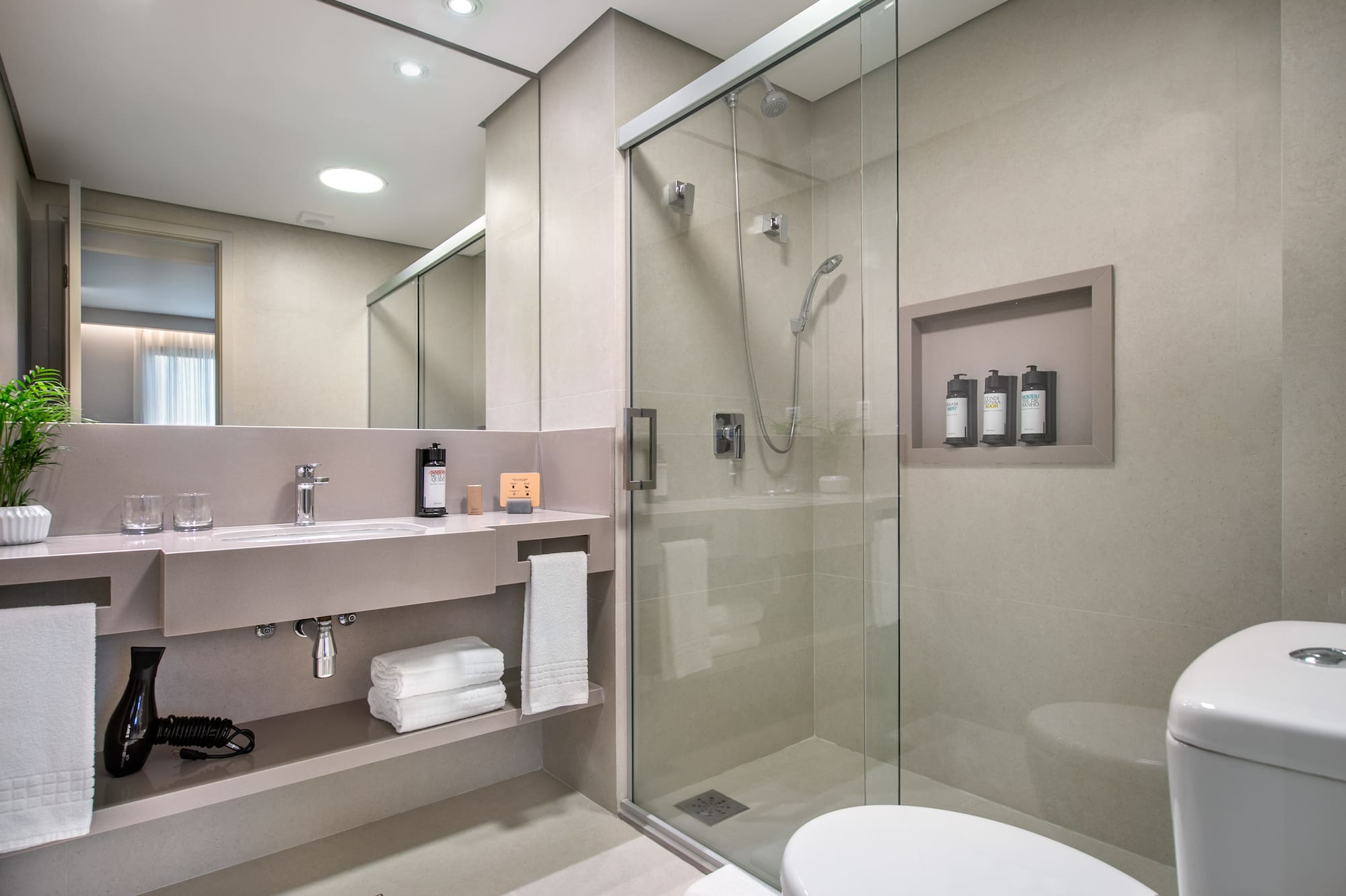 a bathroom with a glass shower and a toilet