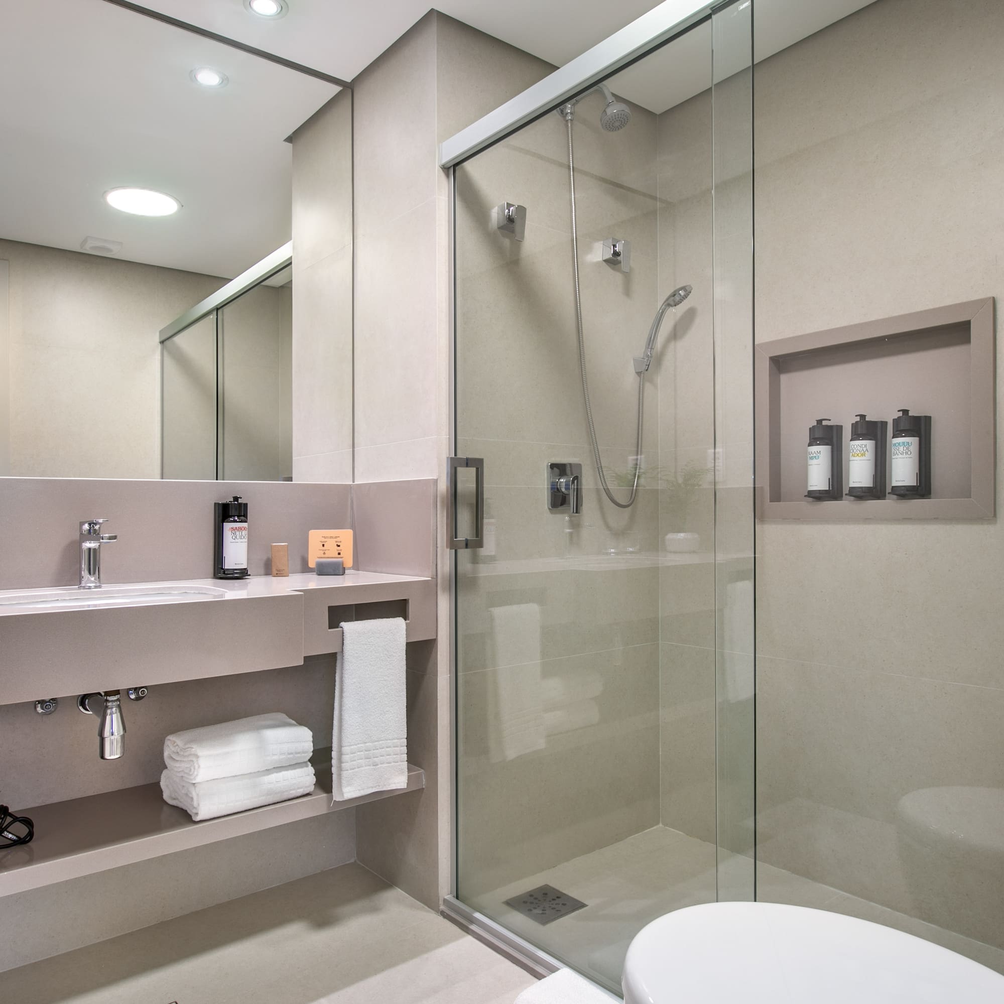 a bathroom with a glass shower and a toilet
