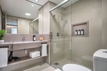 a bathroom with a glass shower and a toilet
