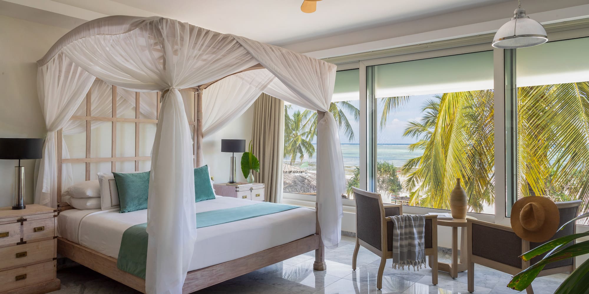 a bedroom with a canopy bed and chairs