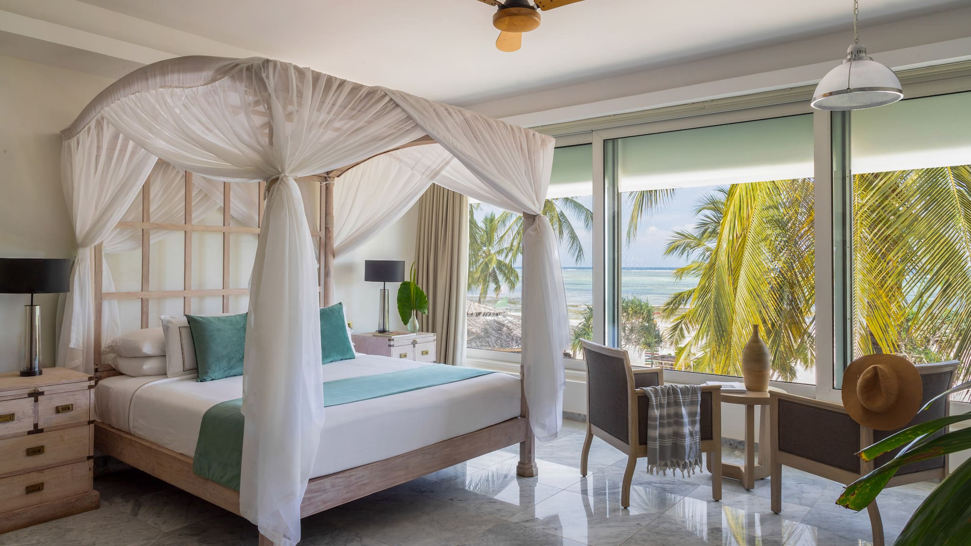 a bedroom with a canopy bed and chairs