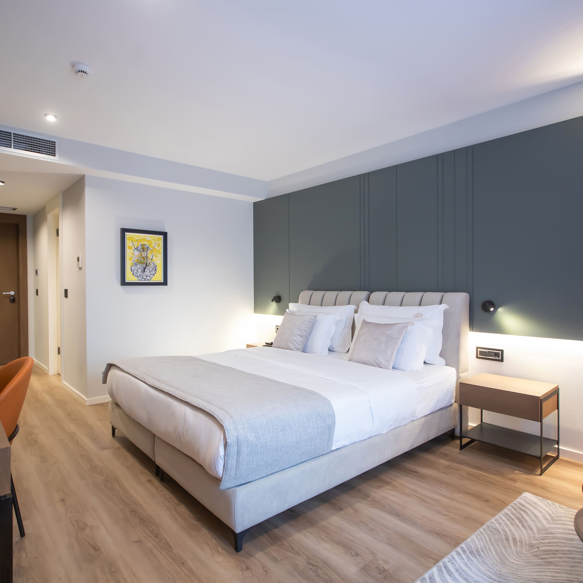 a bedroom with a bed and a chair