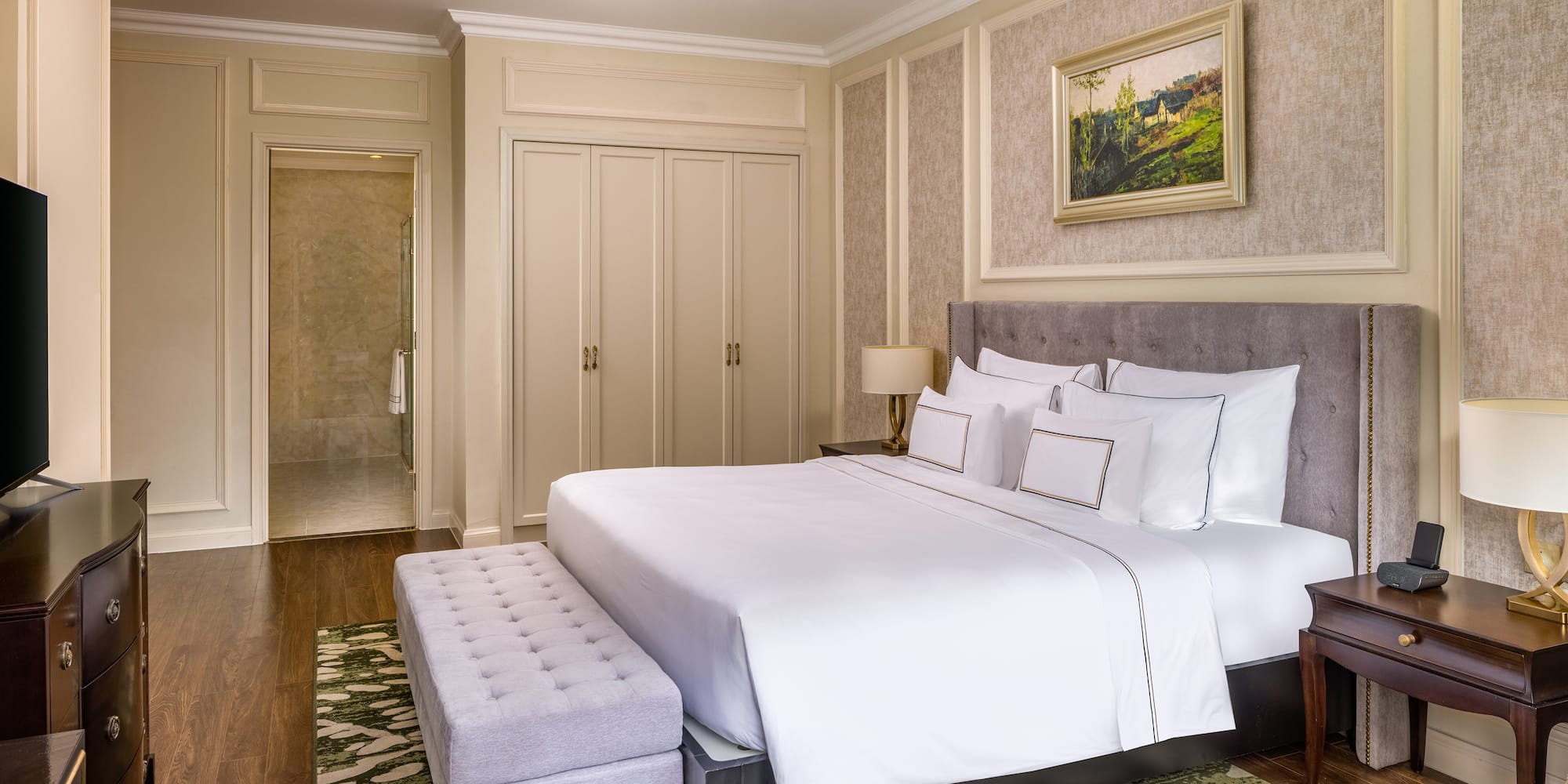 a bedroom with a bed and a bench