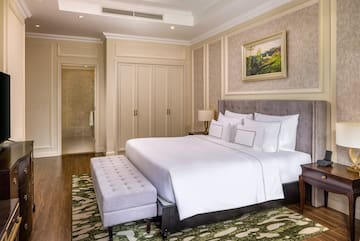a bedroom with a bed and a bench