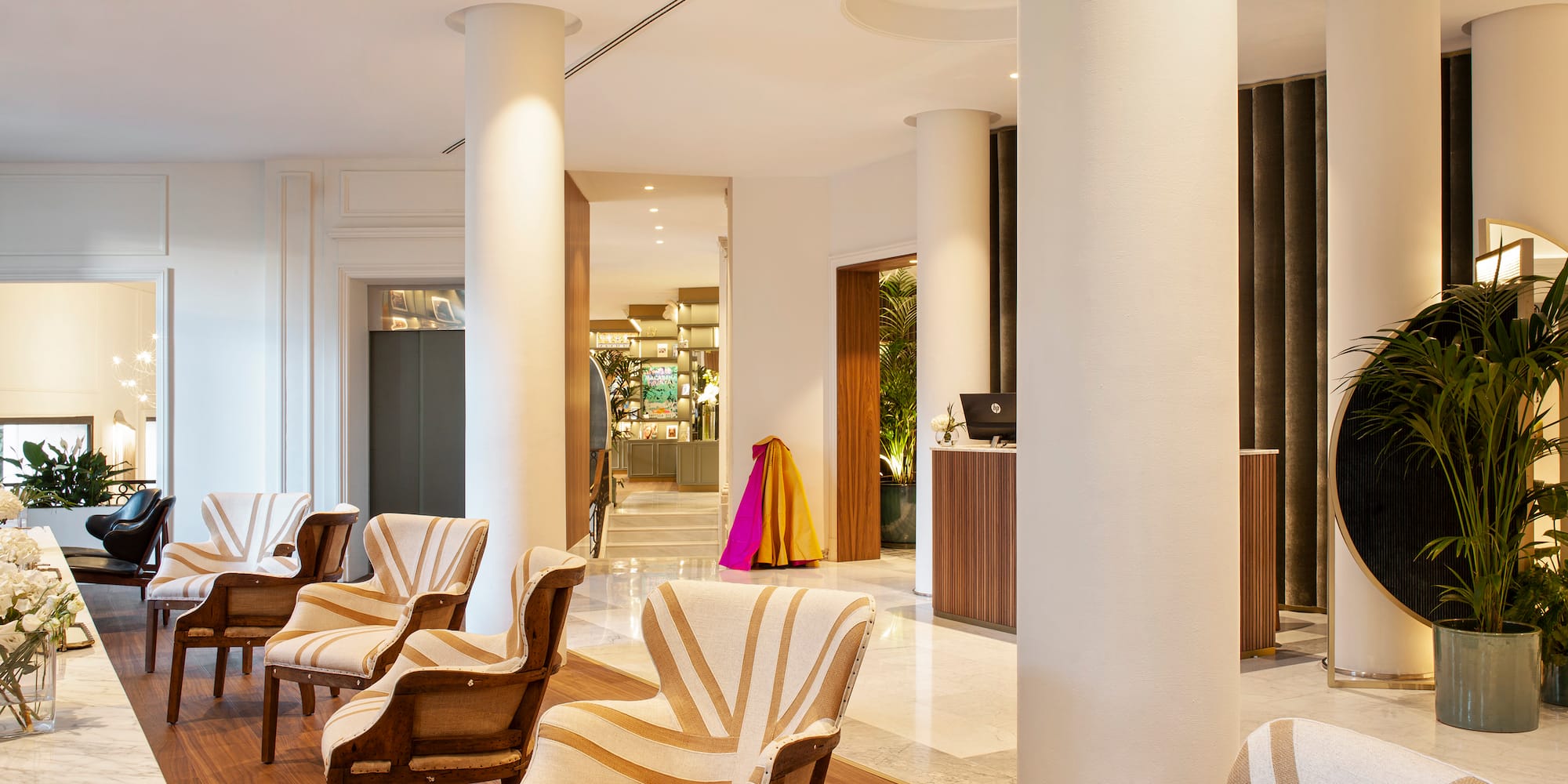 a room with white columns and chairs