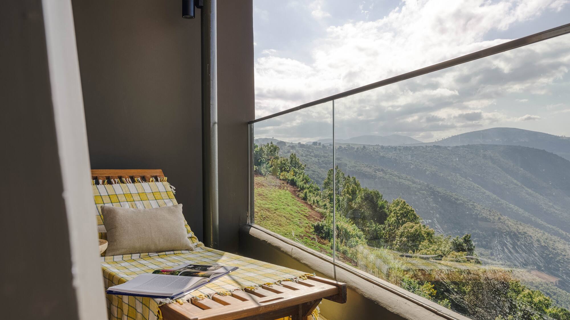 a chair on a balcony overlooking a valley