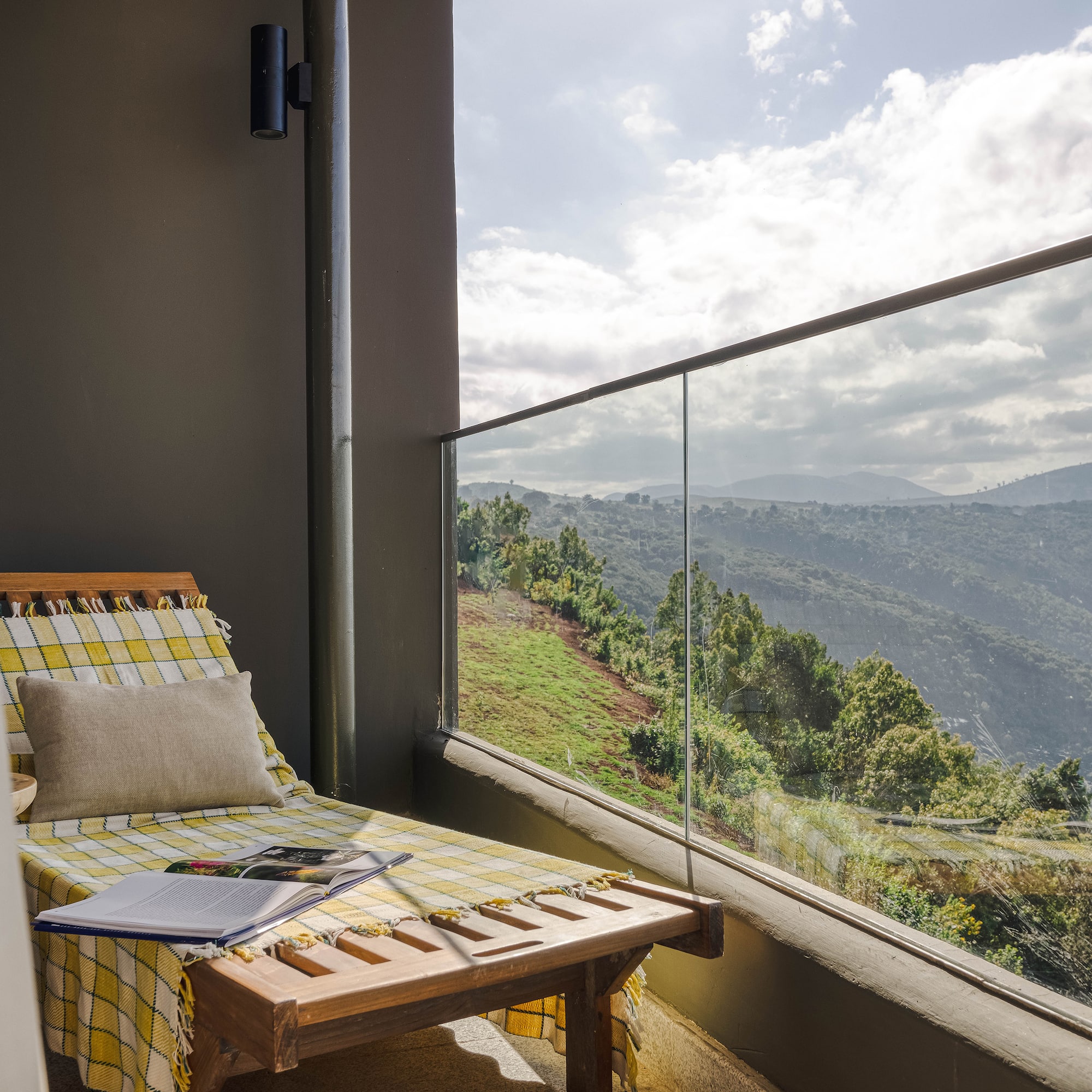 a chair on a balcony overlooking a valley